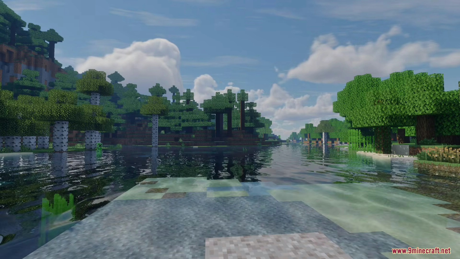 A wide river reflects the beautiful sky and volumetric clouds above