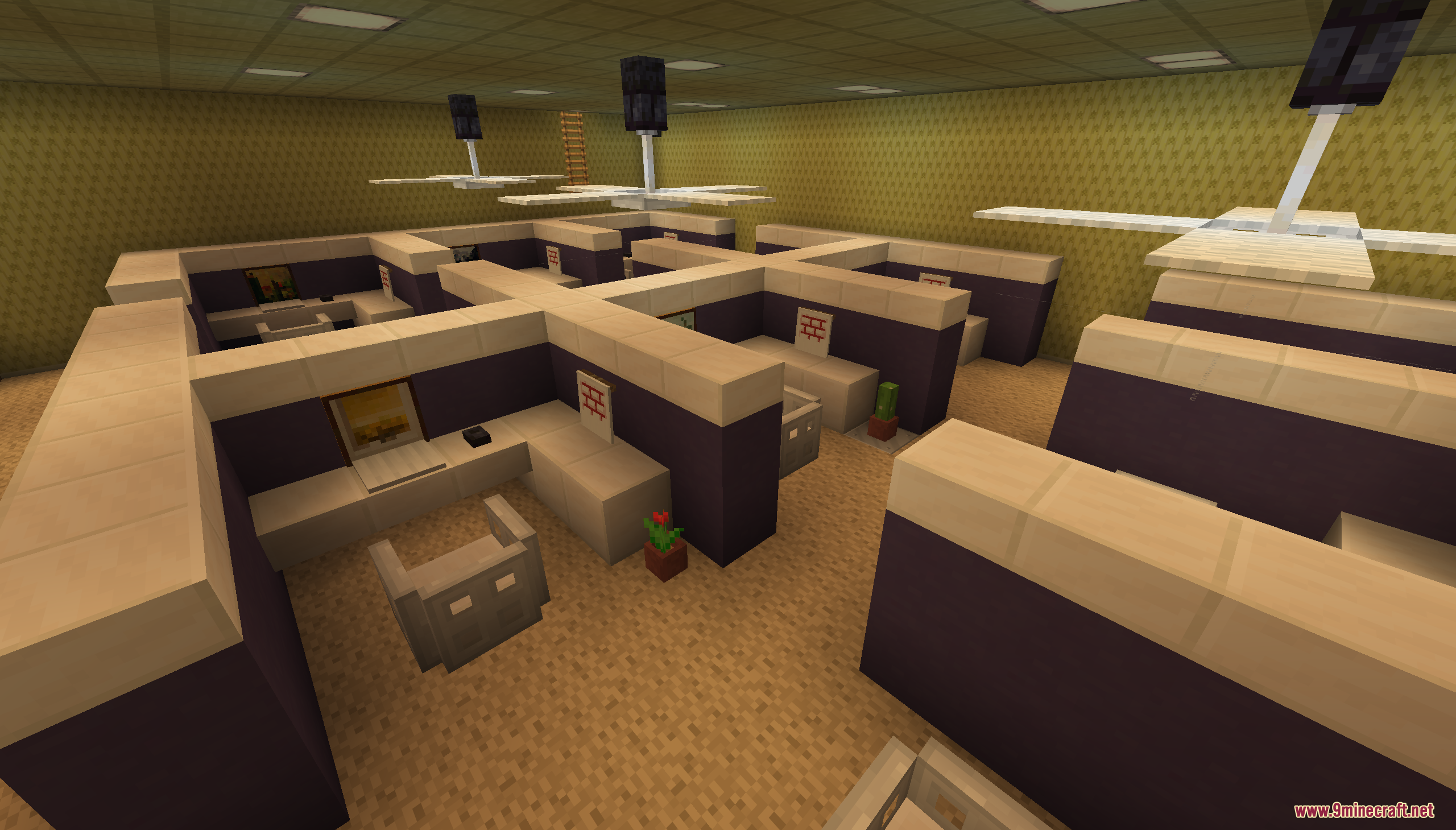 An open-plan office with multiple cubicle workstations