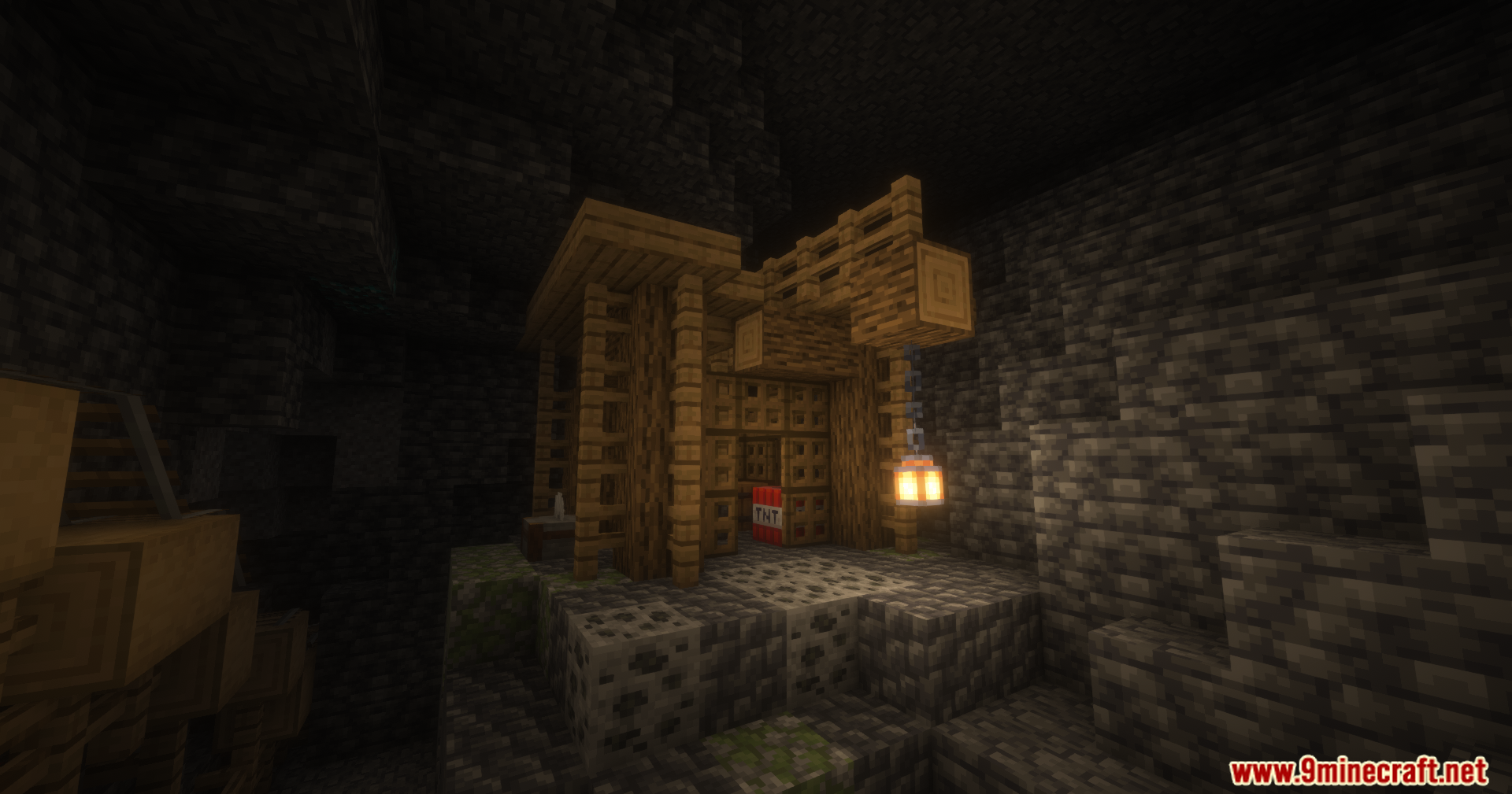 Wooden mining structure with hanging lantern and TNT in dark cave