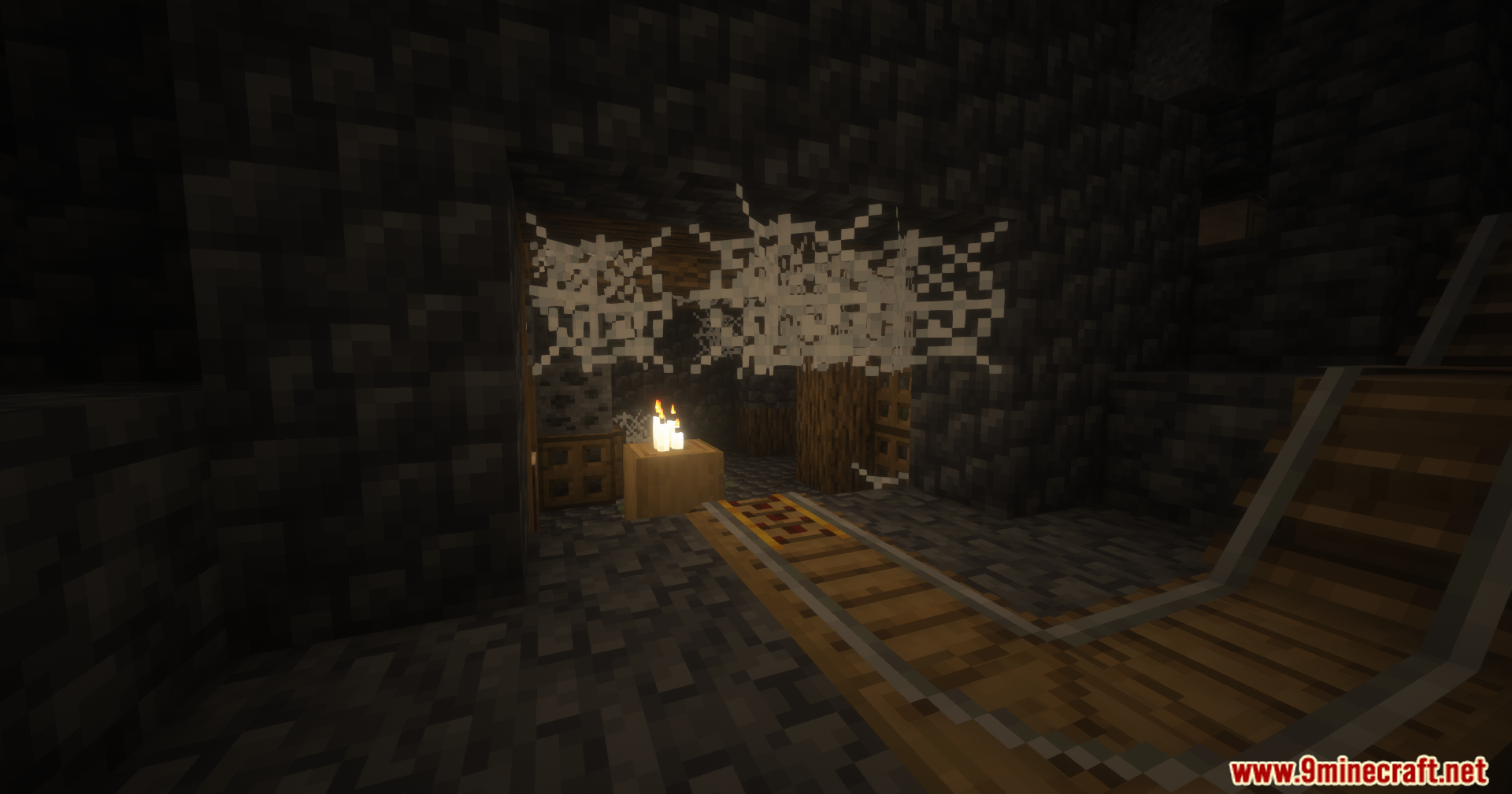Abandoned underground mineshaft with cobwebs minecart rails and lit candles