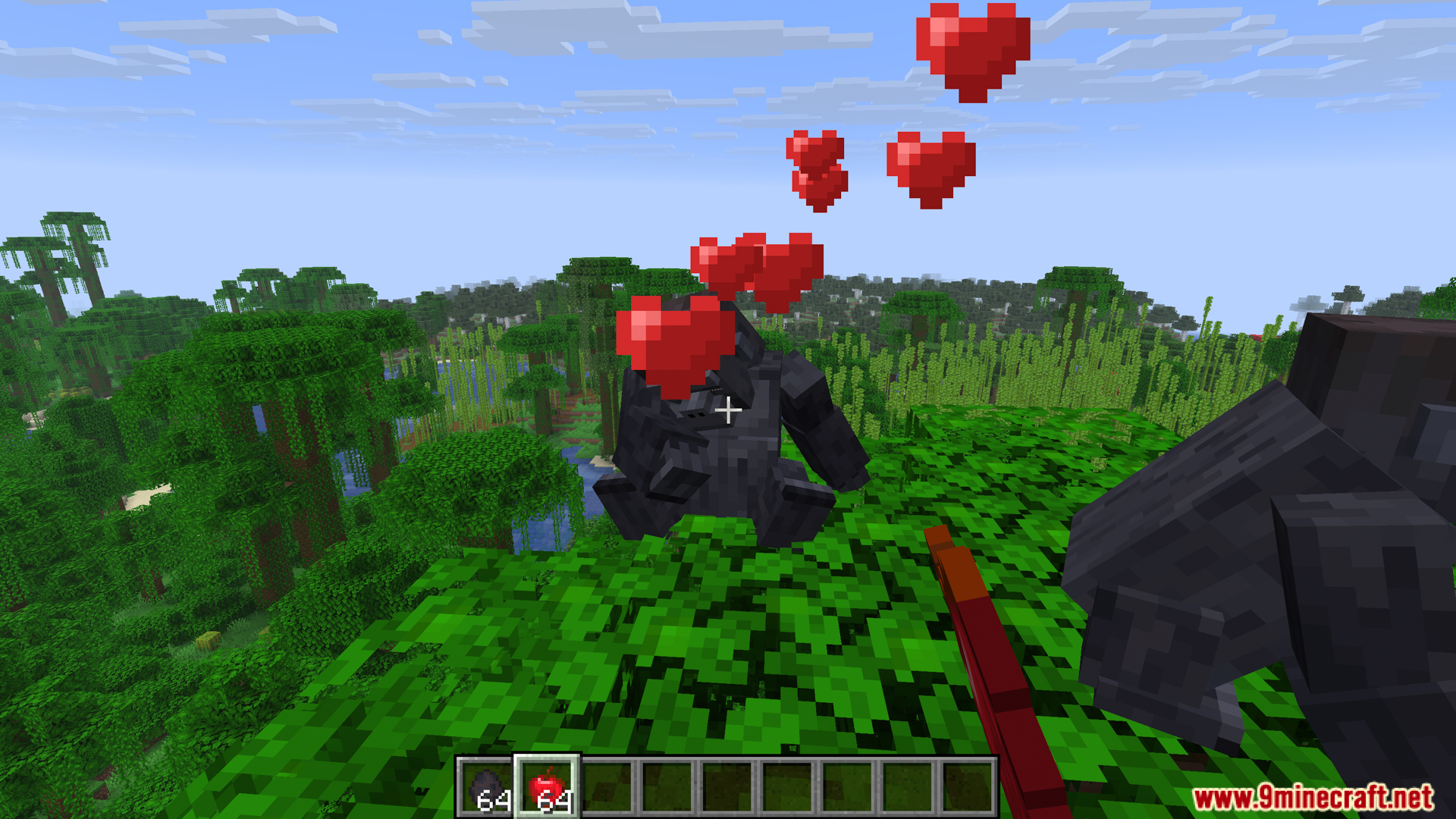 Tamed gorilla sitting on jungle leaves with heart particles above it