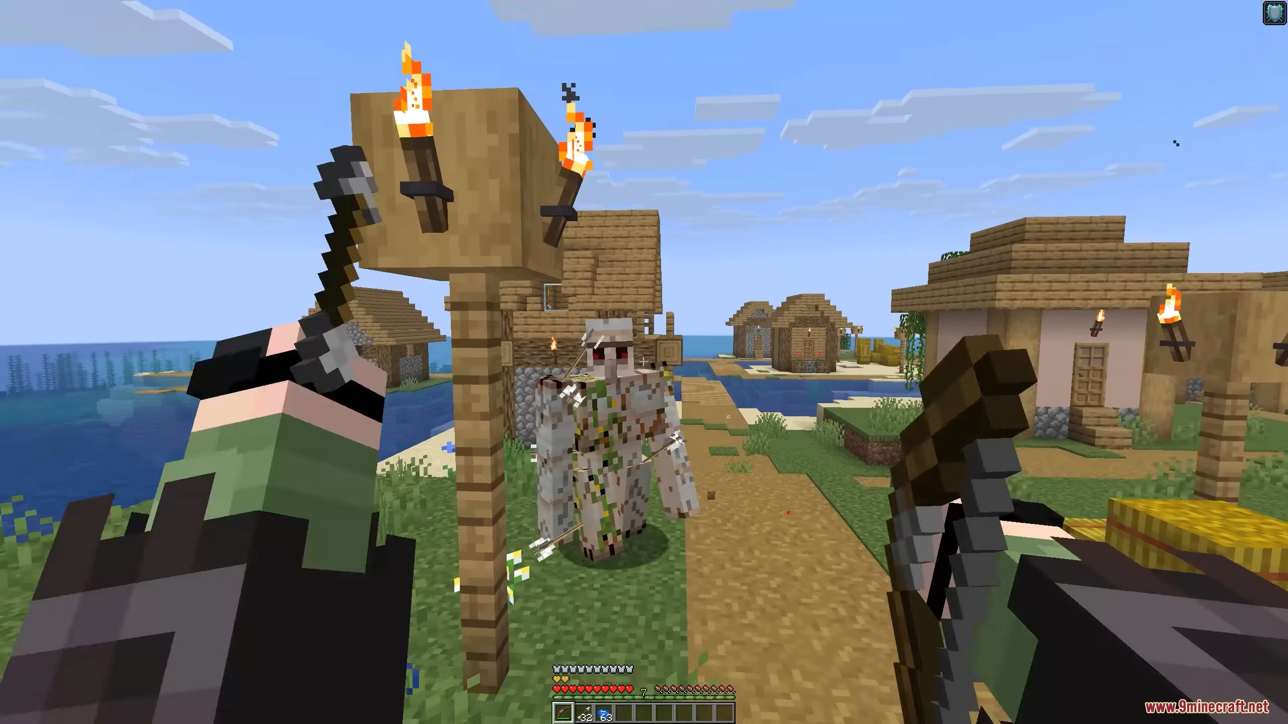 Player holding bow looking at iron golem with arrows in it