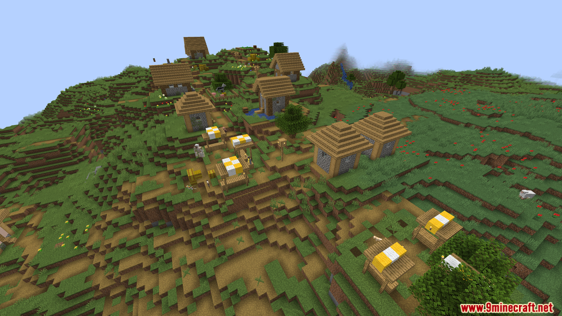 A bustling Minecraft village built on a grassy hillside