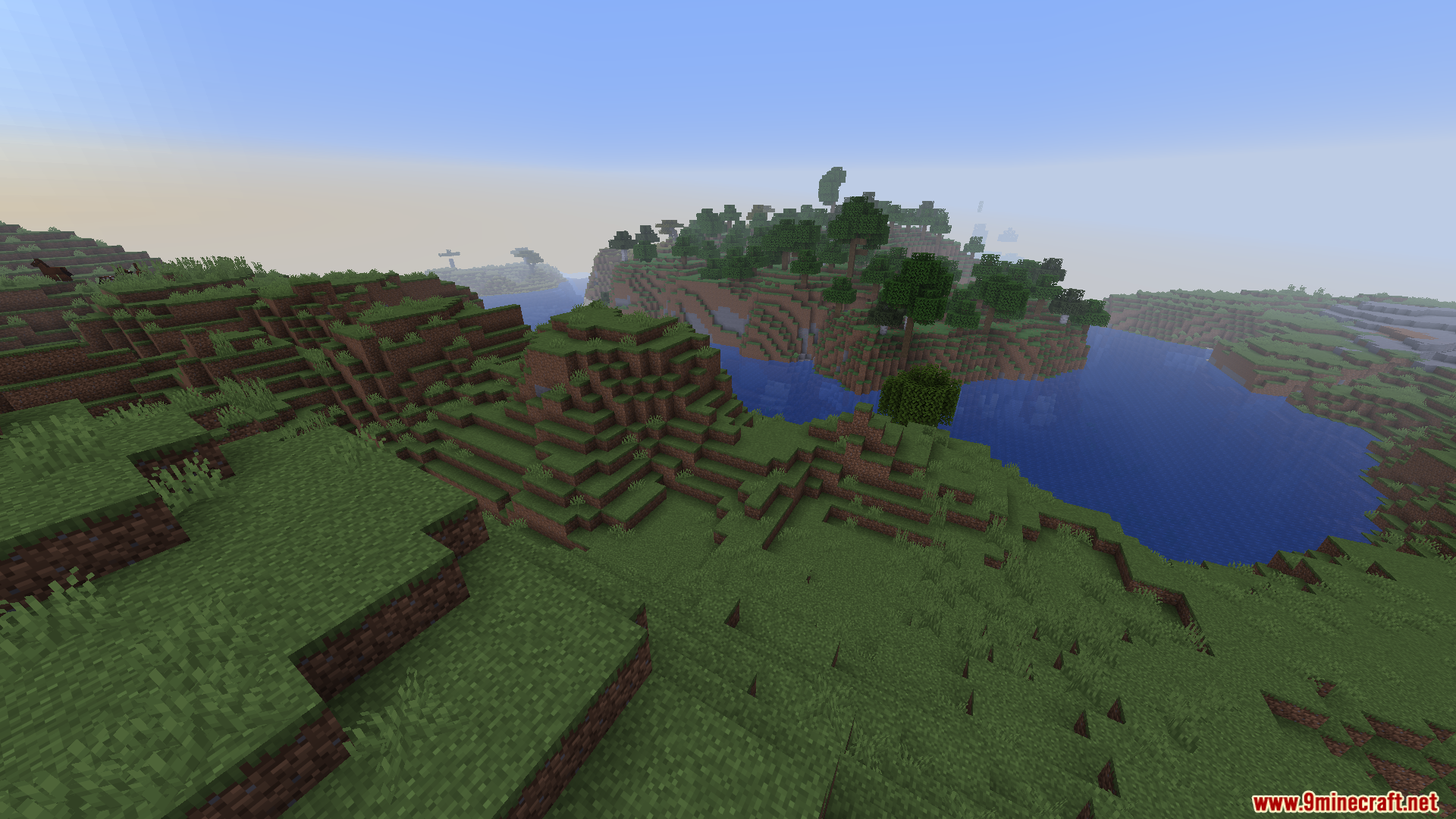 Green grassy hills and a blue river in Minecraft landscape
