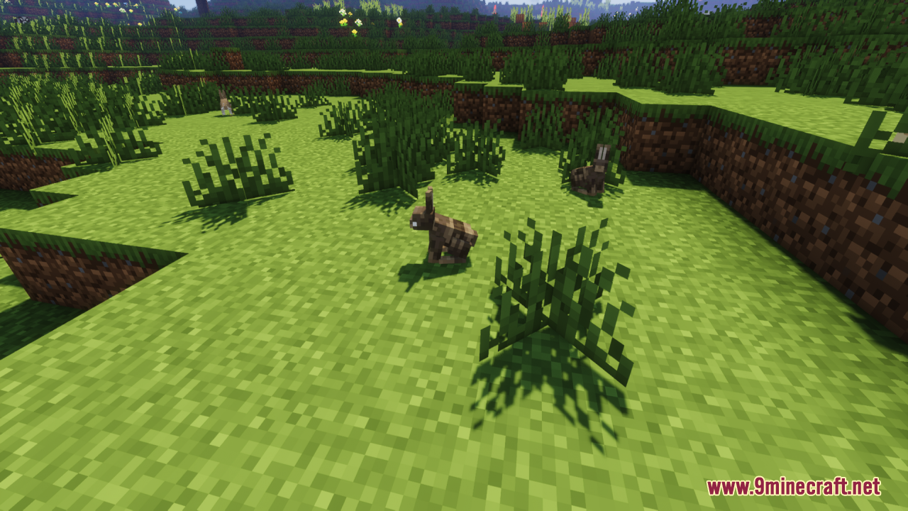 Two custom brown rabbits hopping around a grassy field with bushes