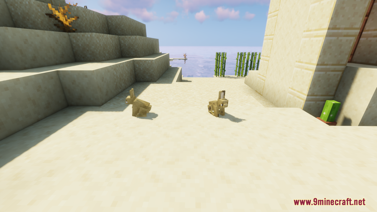 Two sandy rabbits exploring near a desert temple and some water