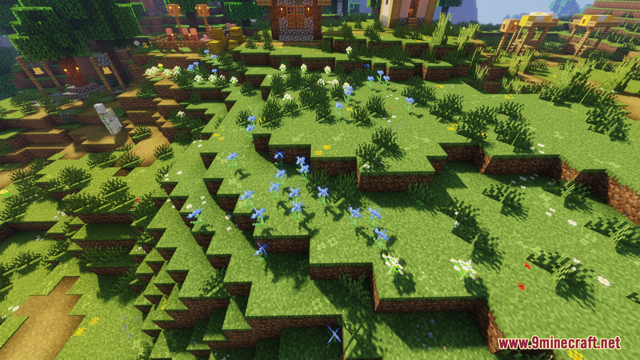 Detailed grass block textures featuring small blue and white flowers