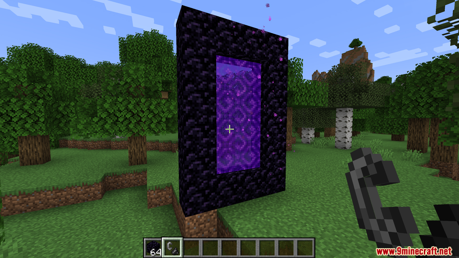 A player stands before a lit Nether portal