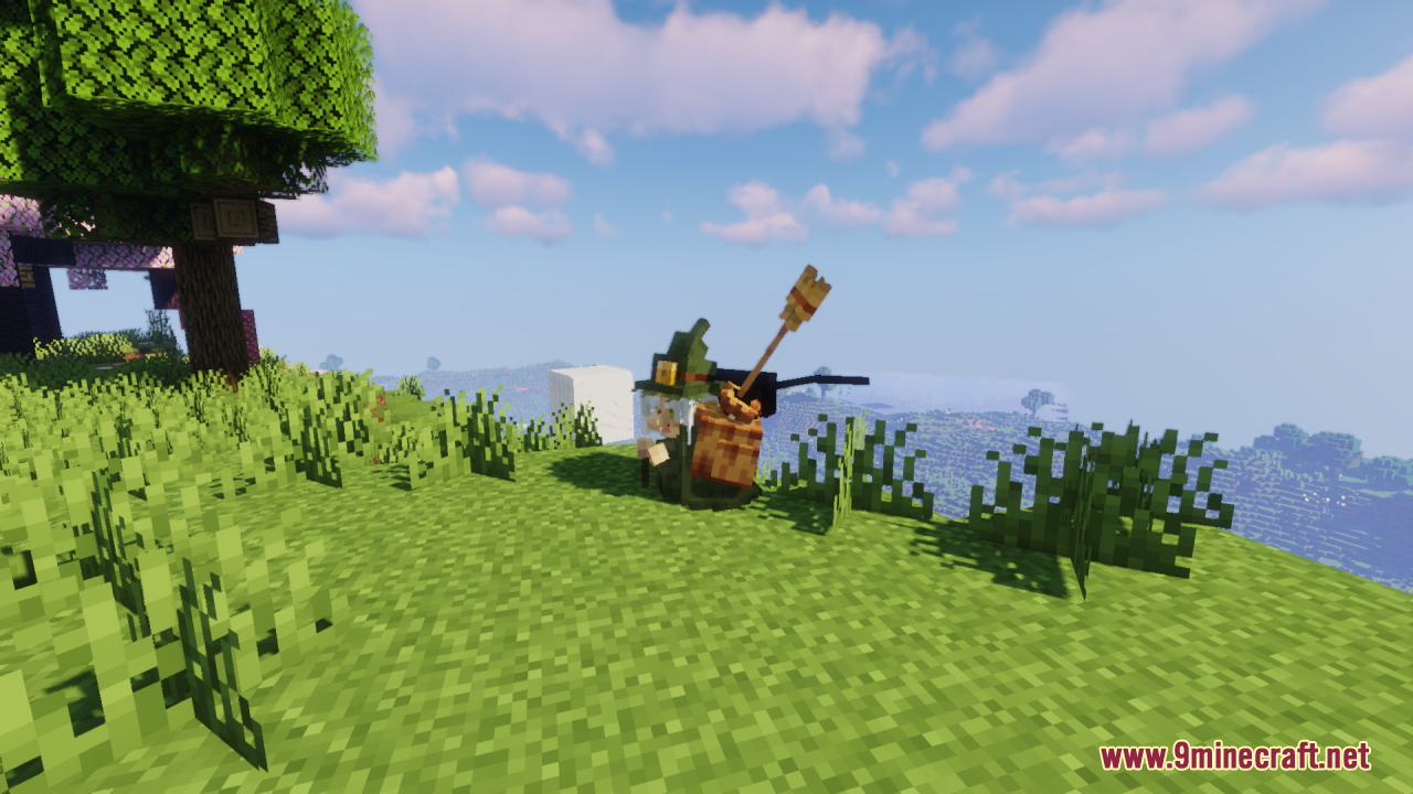 The witch character sitting in a grassy area