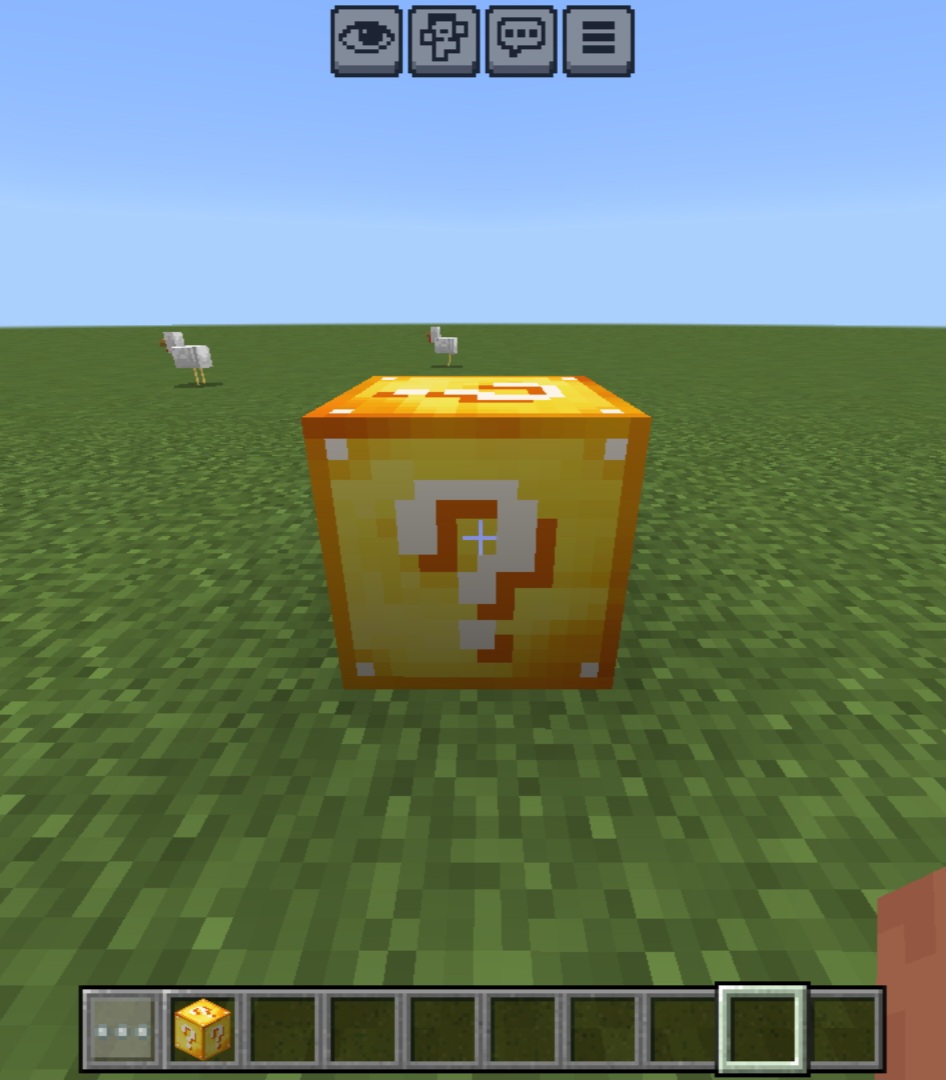 Yellow lucky block with a white question mark on grass