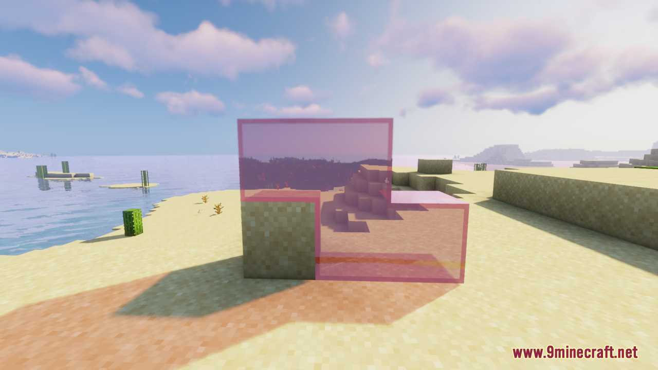 Purple tinted glass blocks placed on a sandy beach