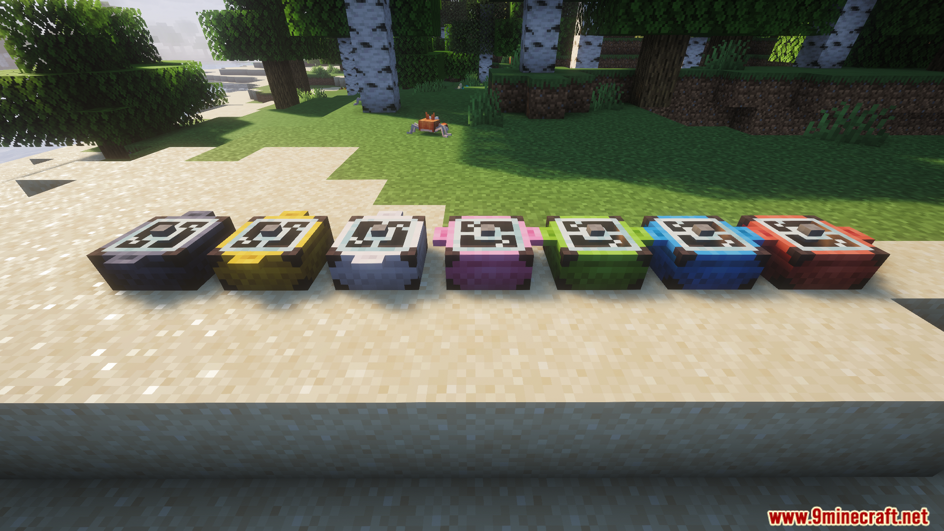 Several different colored campfire pots placed on the sandy beach