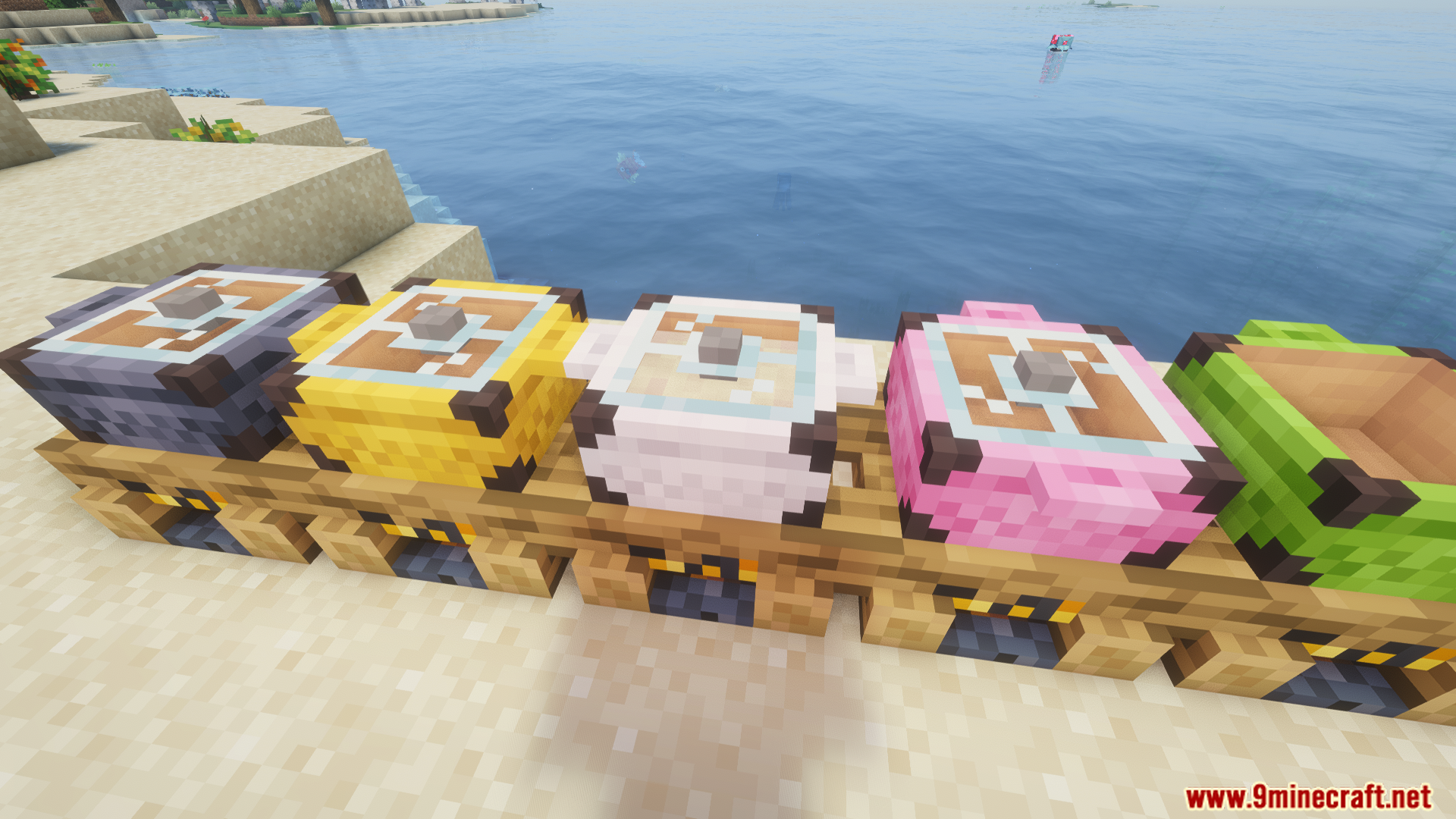 Various colored campfire pots placed on campfires along a sandy beach