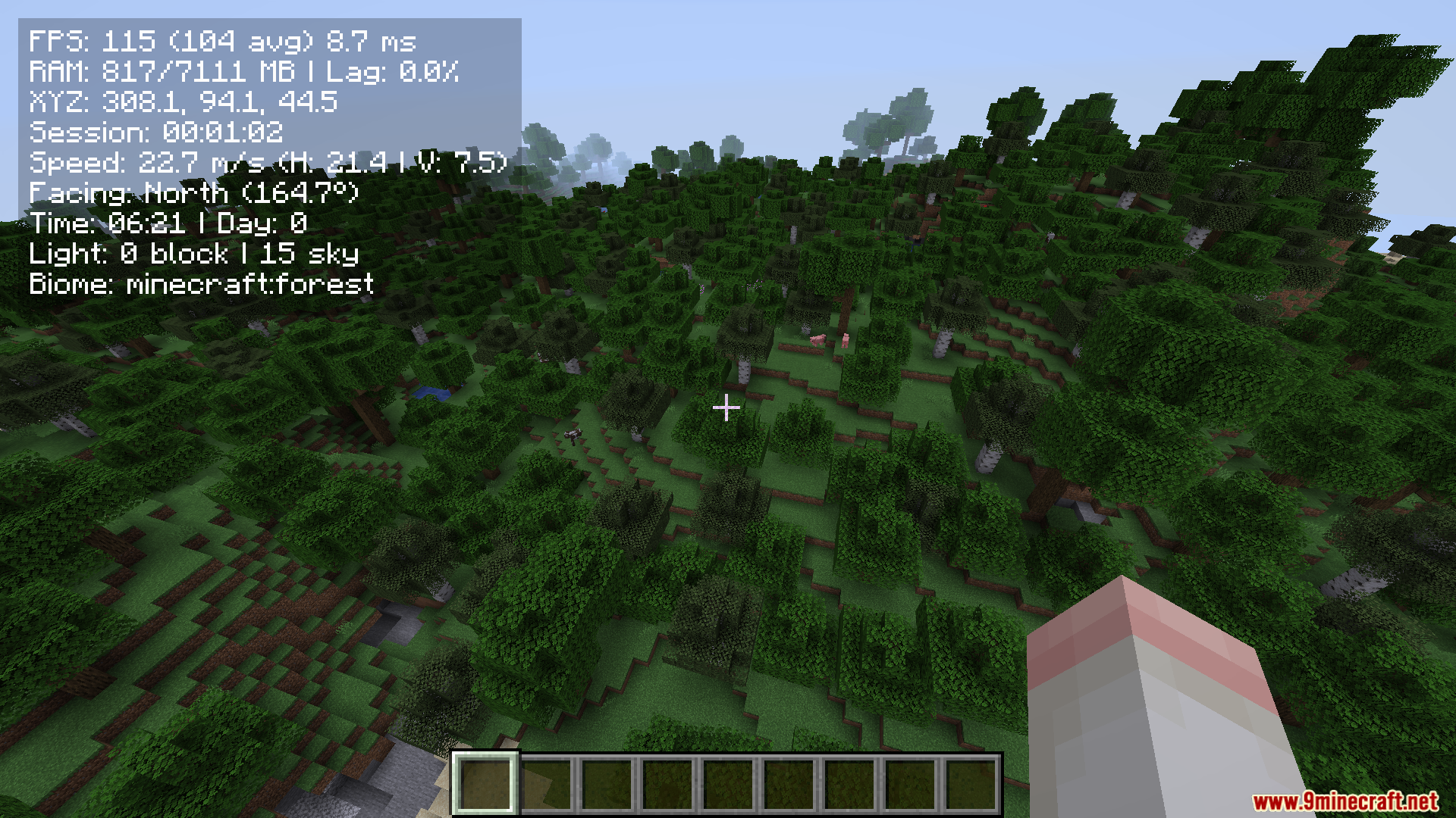 Flying high above a dense forest with performance stats displayed
