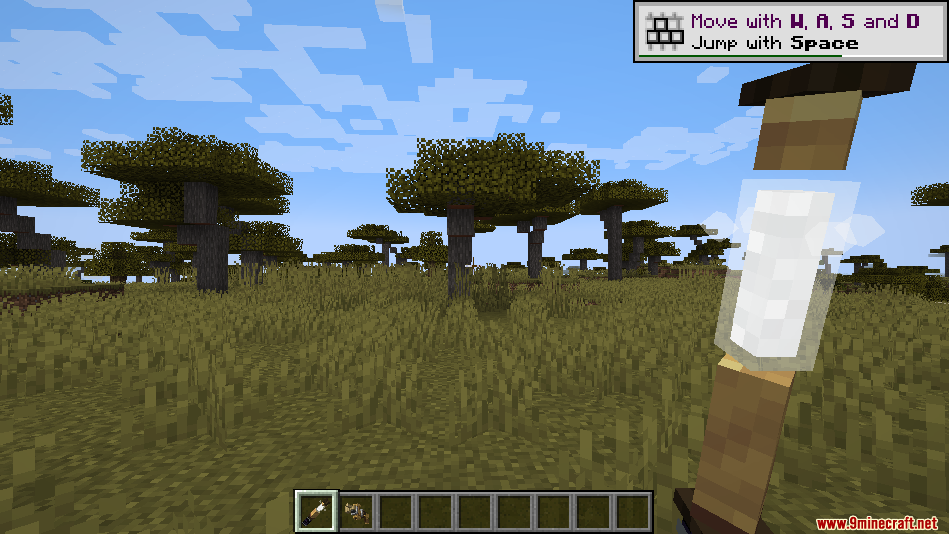 Player holding a mechanical wand item in a savanna biome