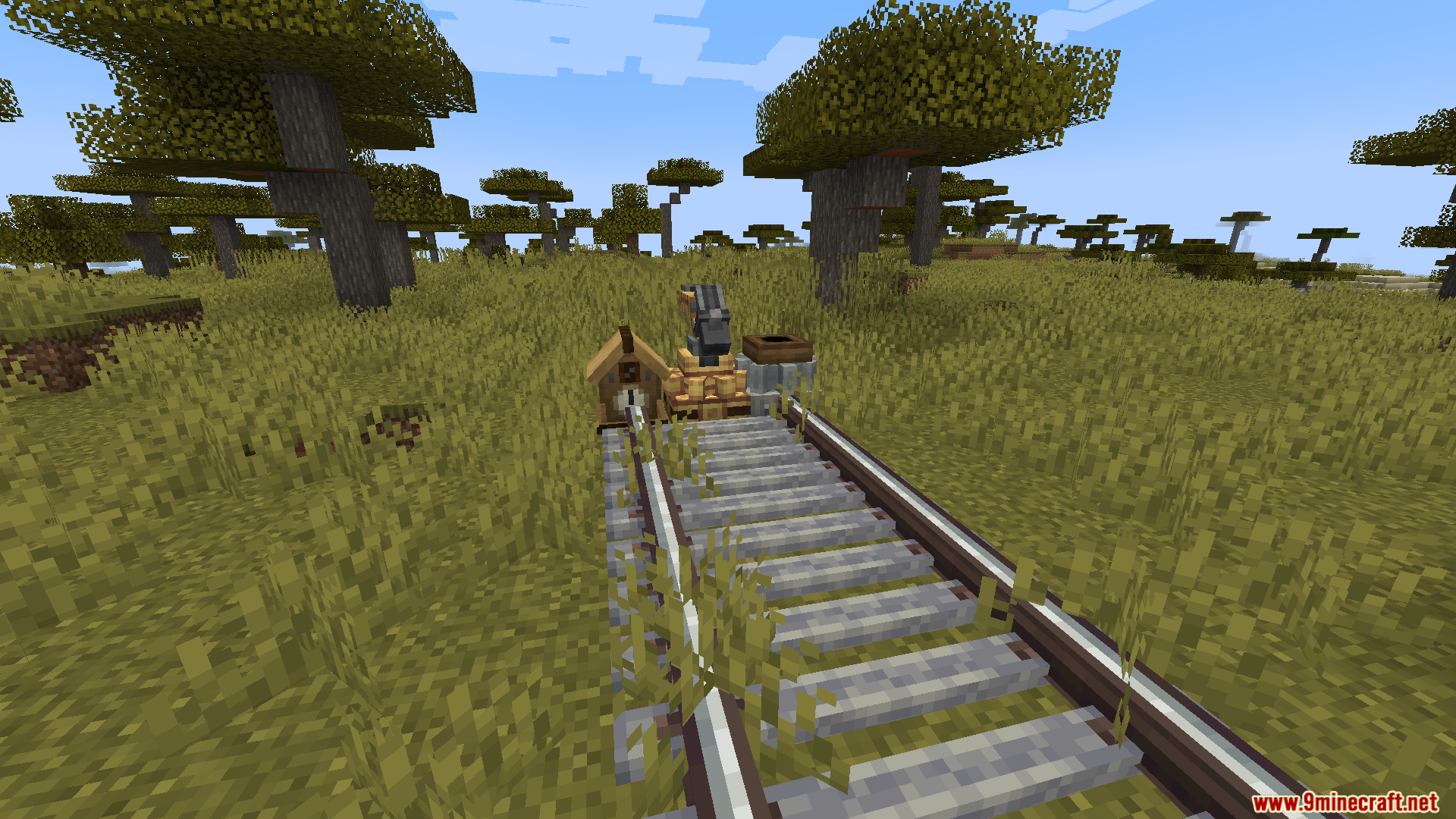 Train tracks placed next to a mechanical arm and station block