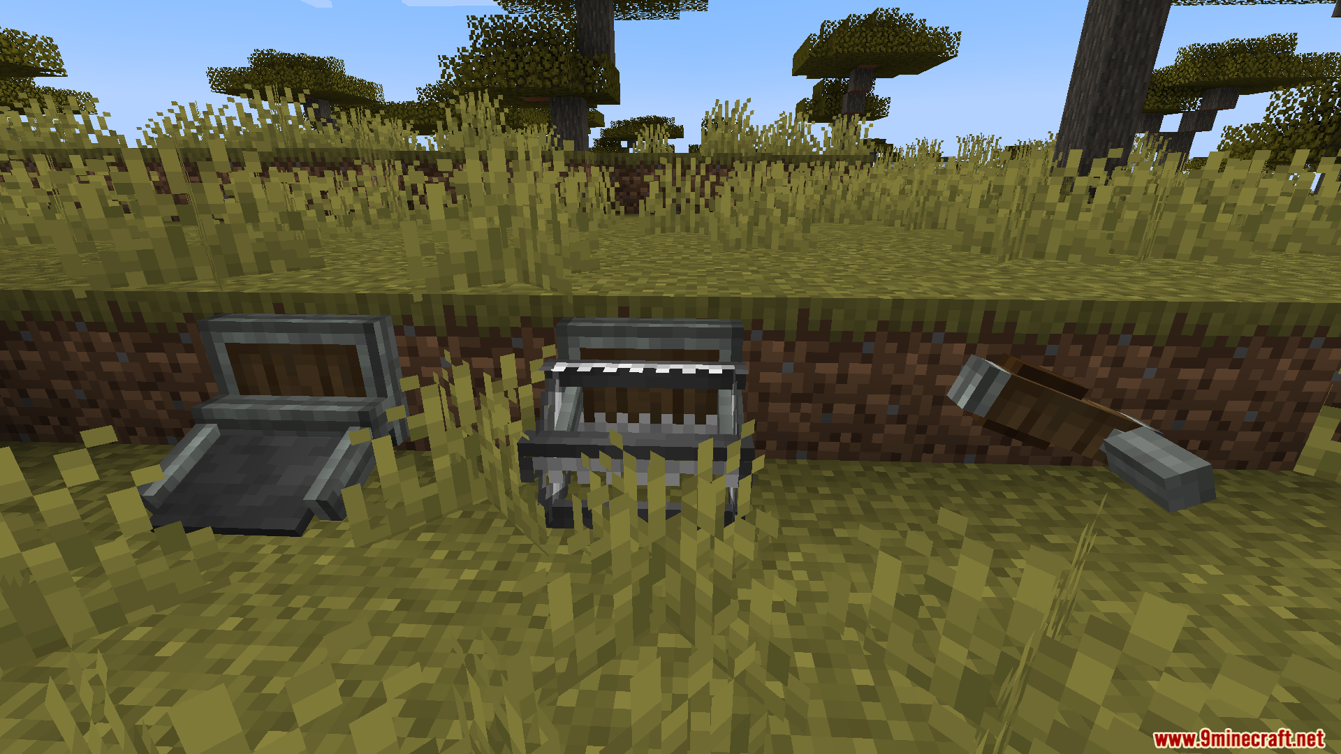 Three different metal trap mechanisms placed on grass blocks