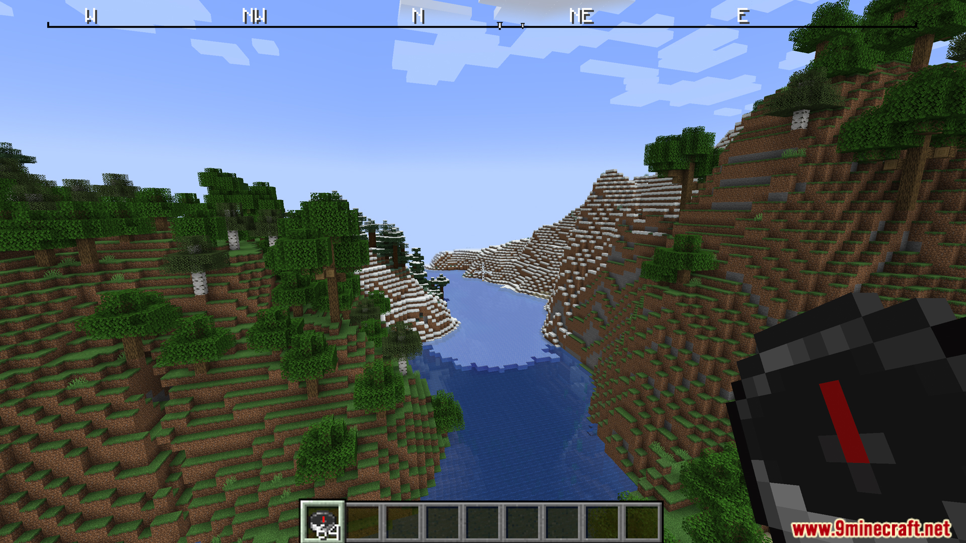 River valley view with compass held and top compass ribbon