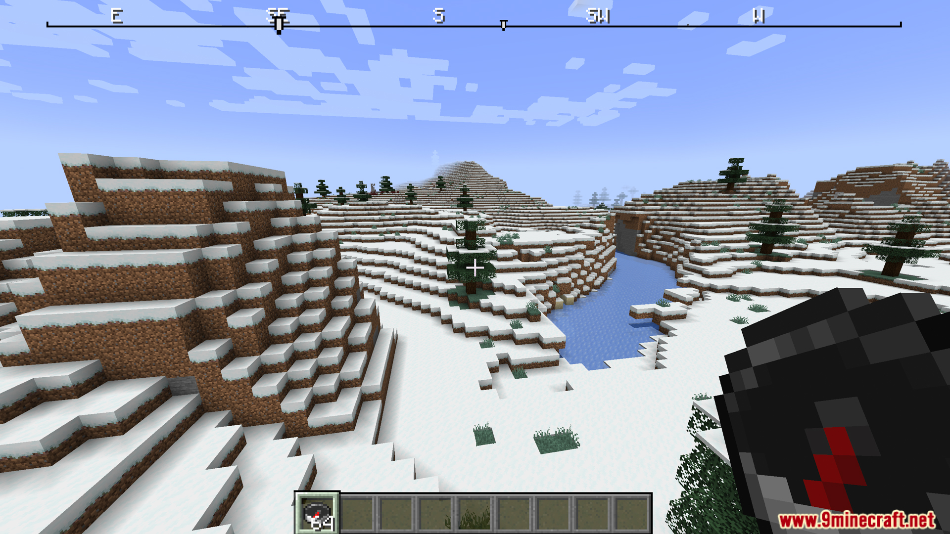 Snowy landscape view with compass held and top compass ribbon