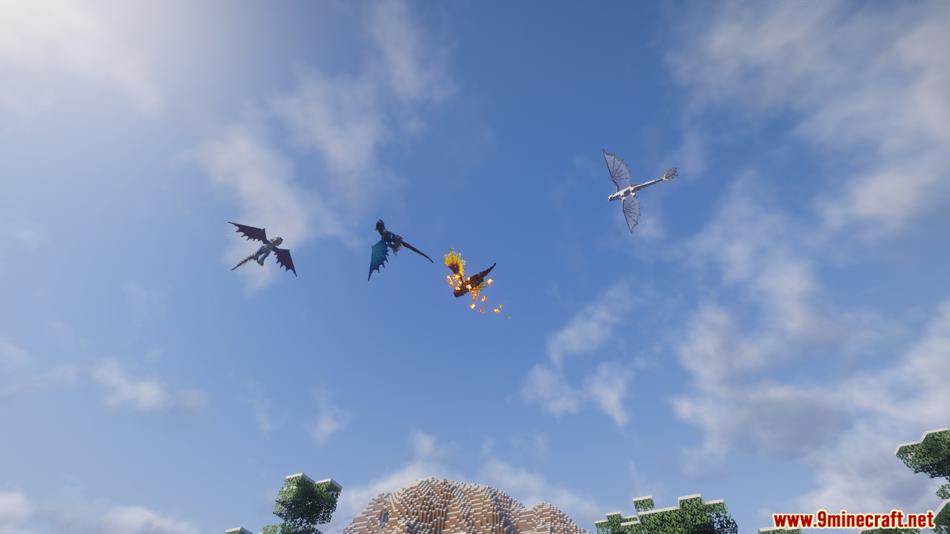 A group of dragons flying together in the blue sky