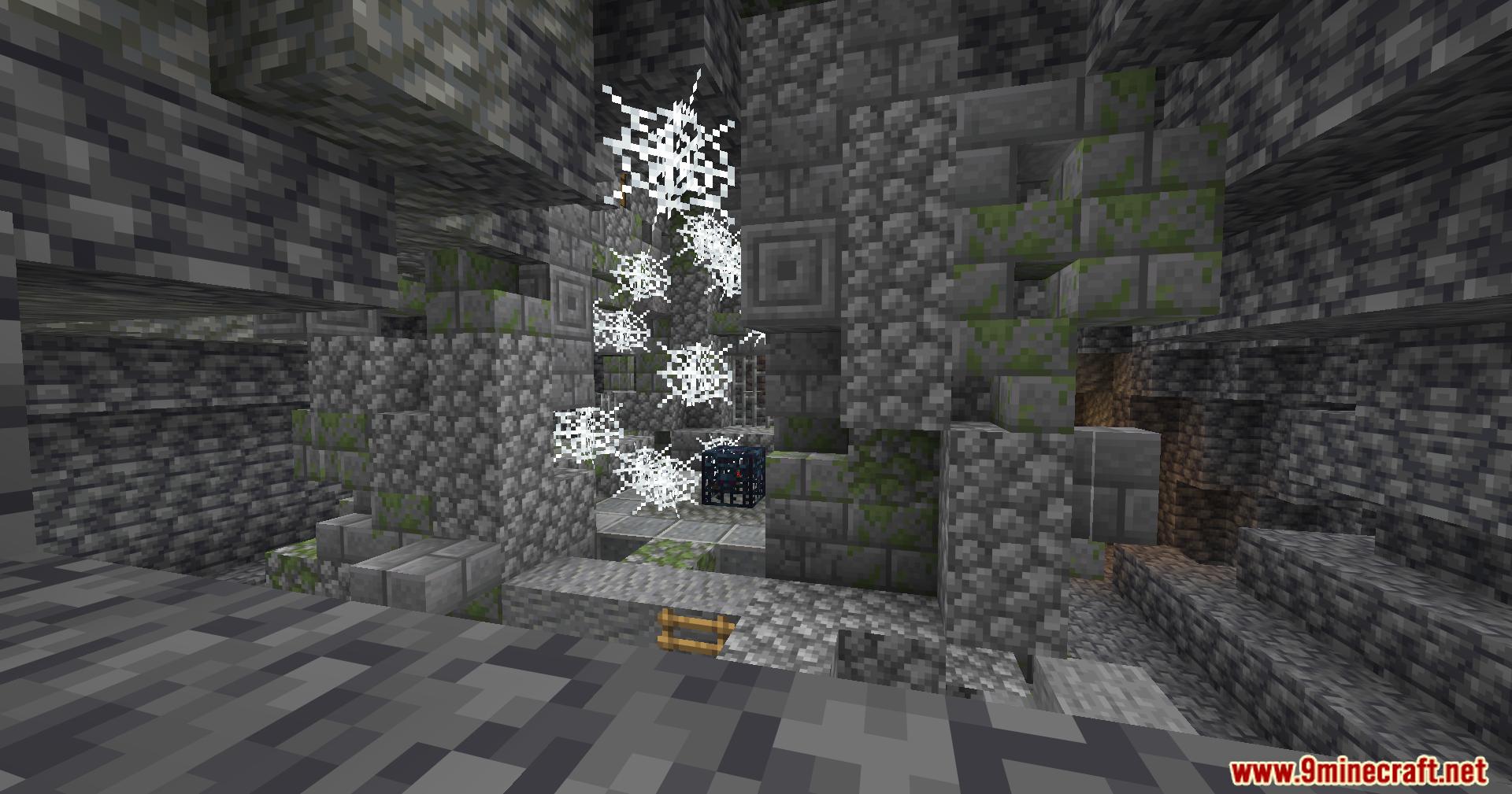 Ruined stone dungeon entrance filled with cobwebs and a mob spawner