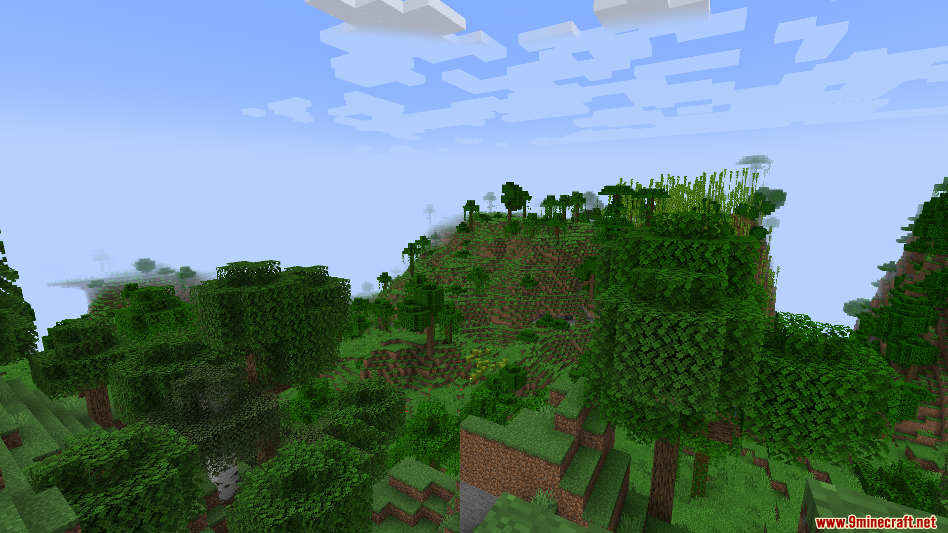 A vast green landscape with rolling hills and trees