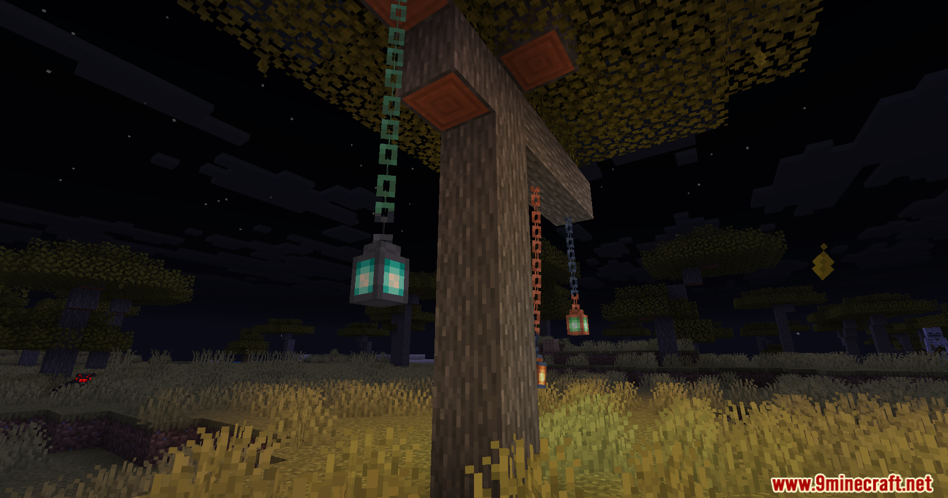 Lanterns attached to chains swinging backward in the night sky