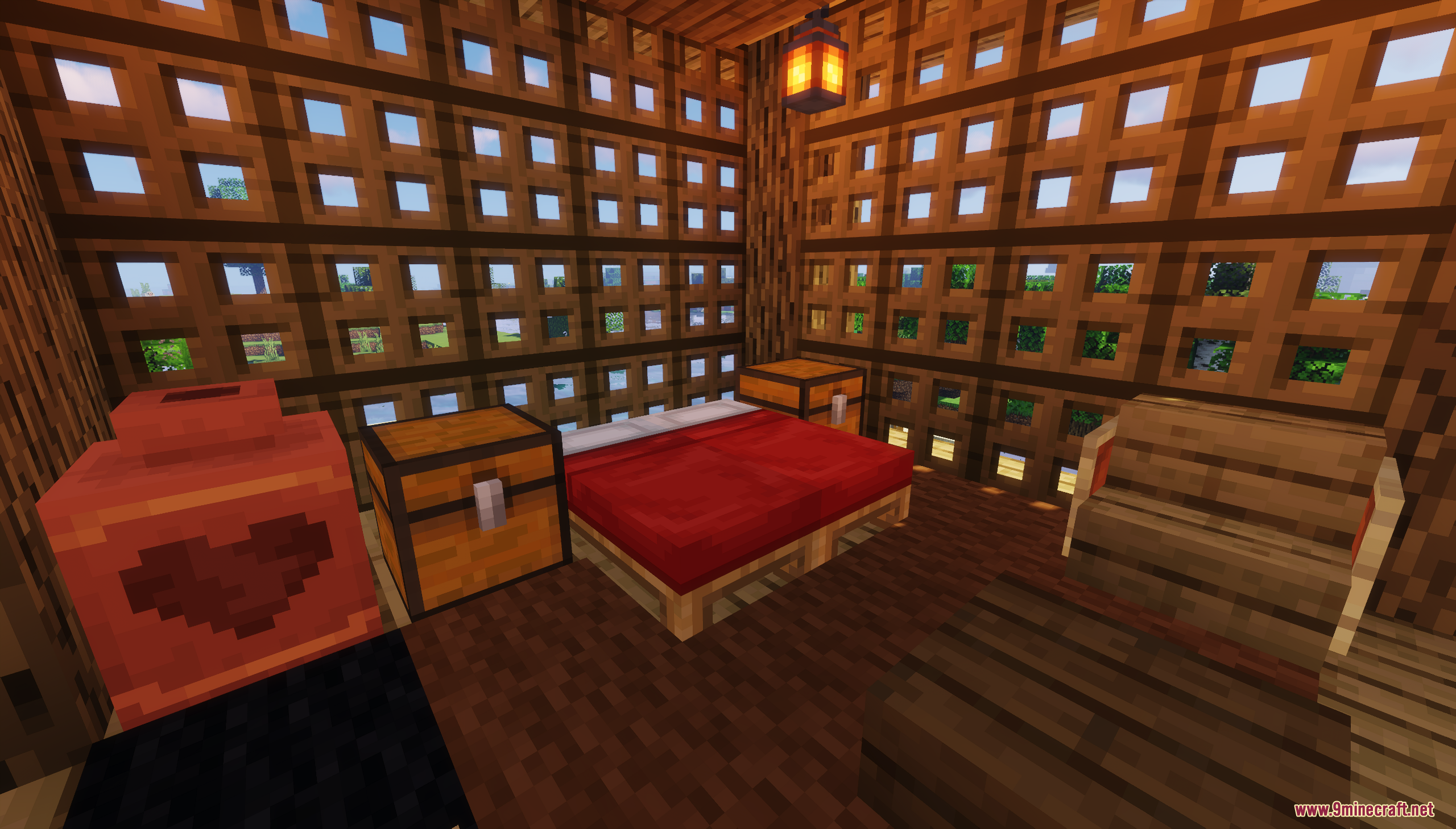 A cozy bedroom with a red bed and chests