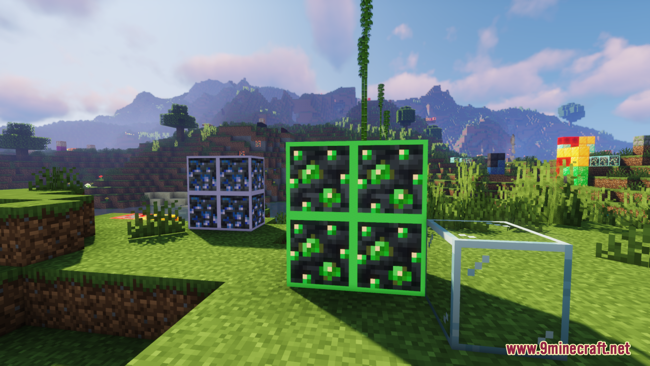Glowing emerald ores displayed next to lapis lazuli and glass blocks