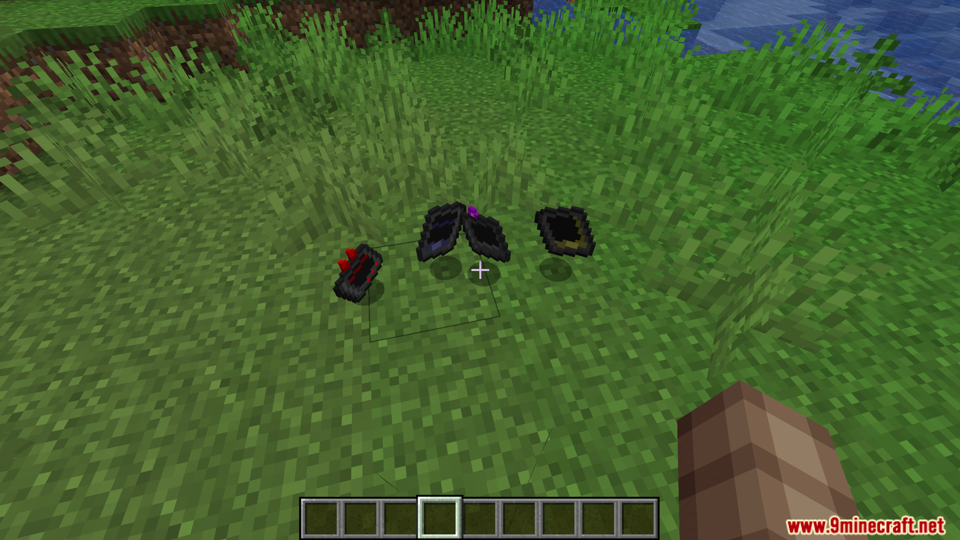Gtceu Terminals Mod Screenshot 13 Three black terminal gadgets dropped on grass in Minecraft