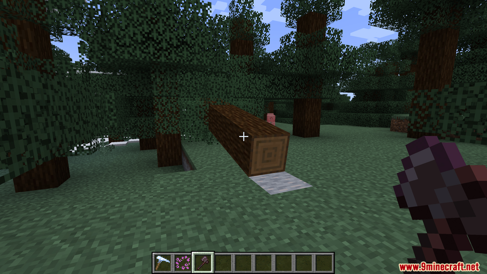 Large wooden tree log falling sideways after player chops it down