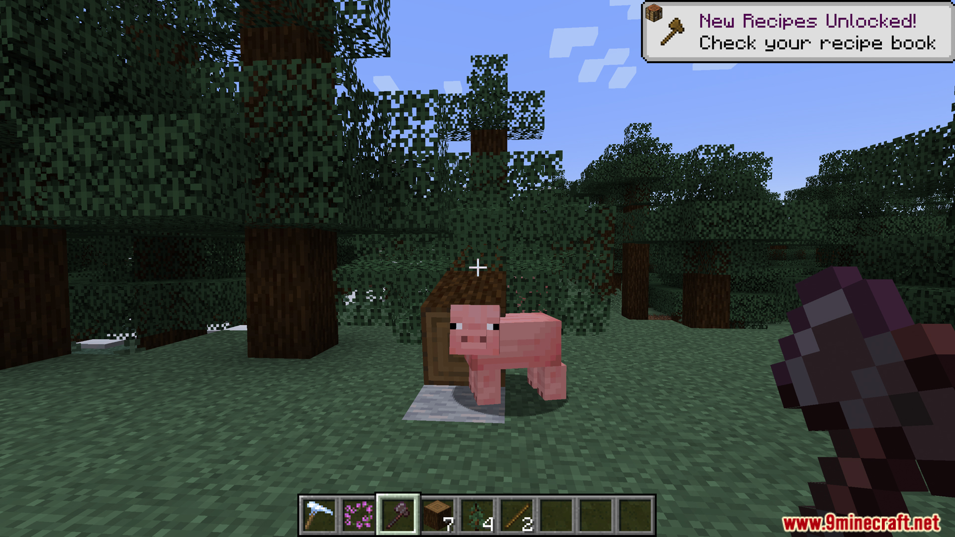 Player holding an axe near a pig and a fallen log