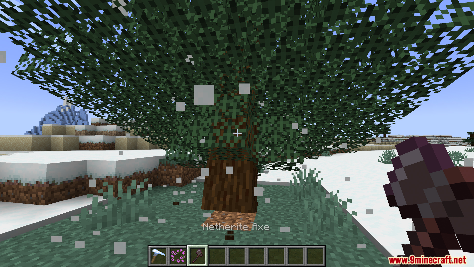 Player holding a netherite axe looking at an ivy covered tree