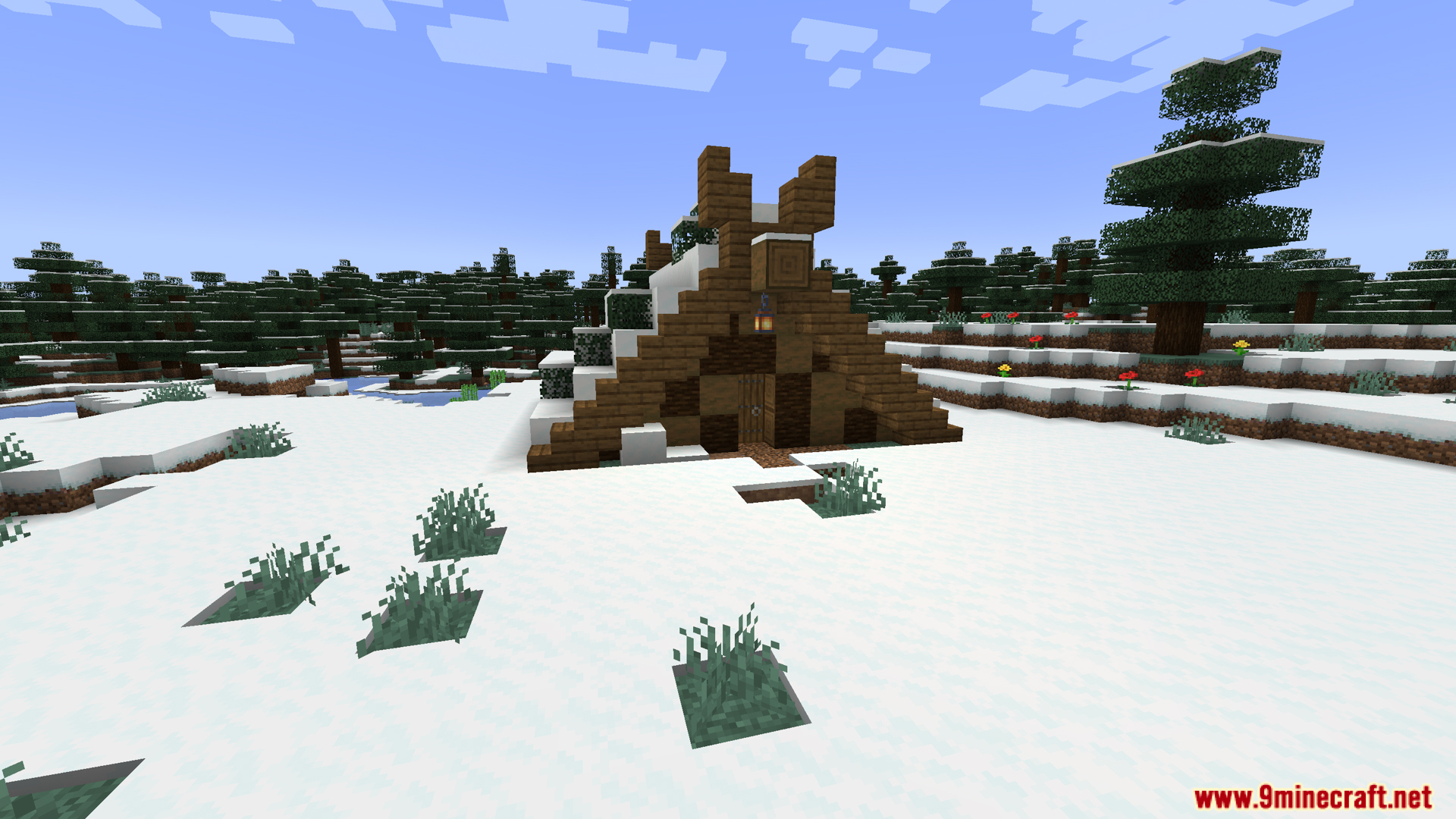 Small wooden tent structure covered with snow in a winter landscape