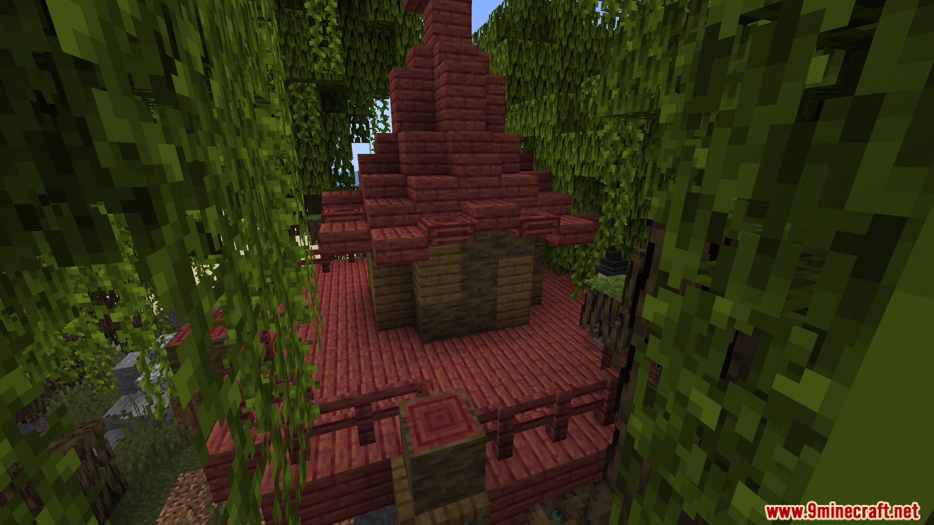 Red mangrove wood hut structure surrounded by dense green swamp vegetation