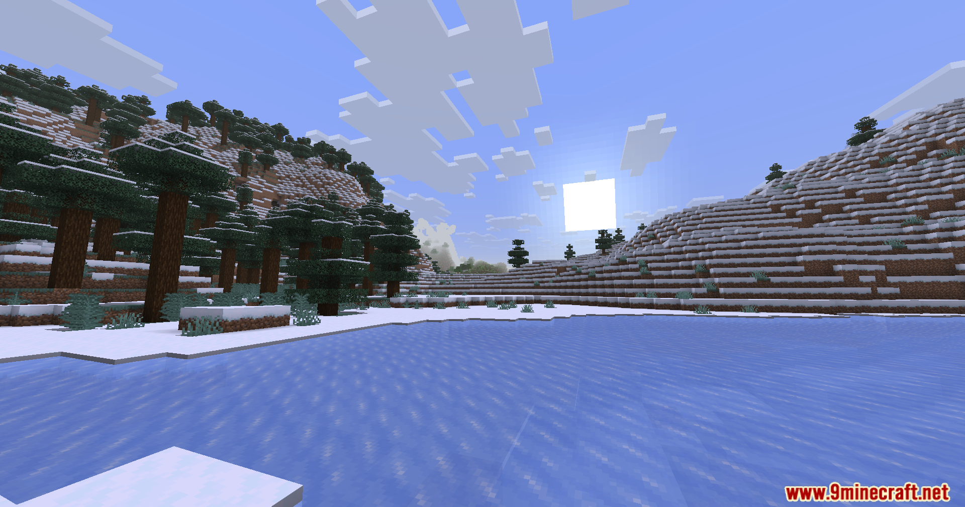 Snowy landscape with a frozen river and pine trees