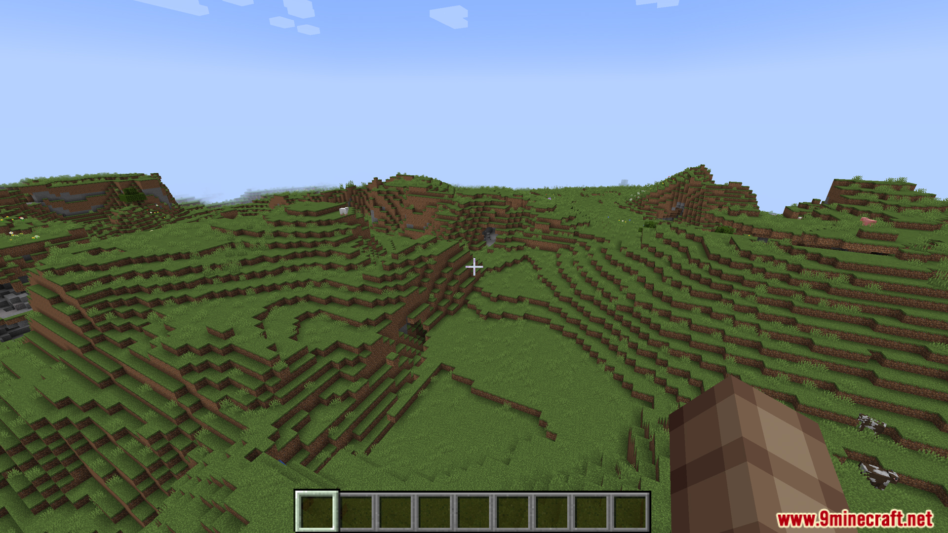 Legume Delight Mod Screenshot 2 Player looking at a grassy landscape with hills and cows