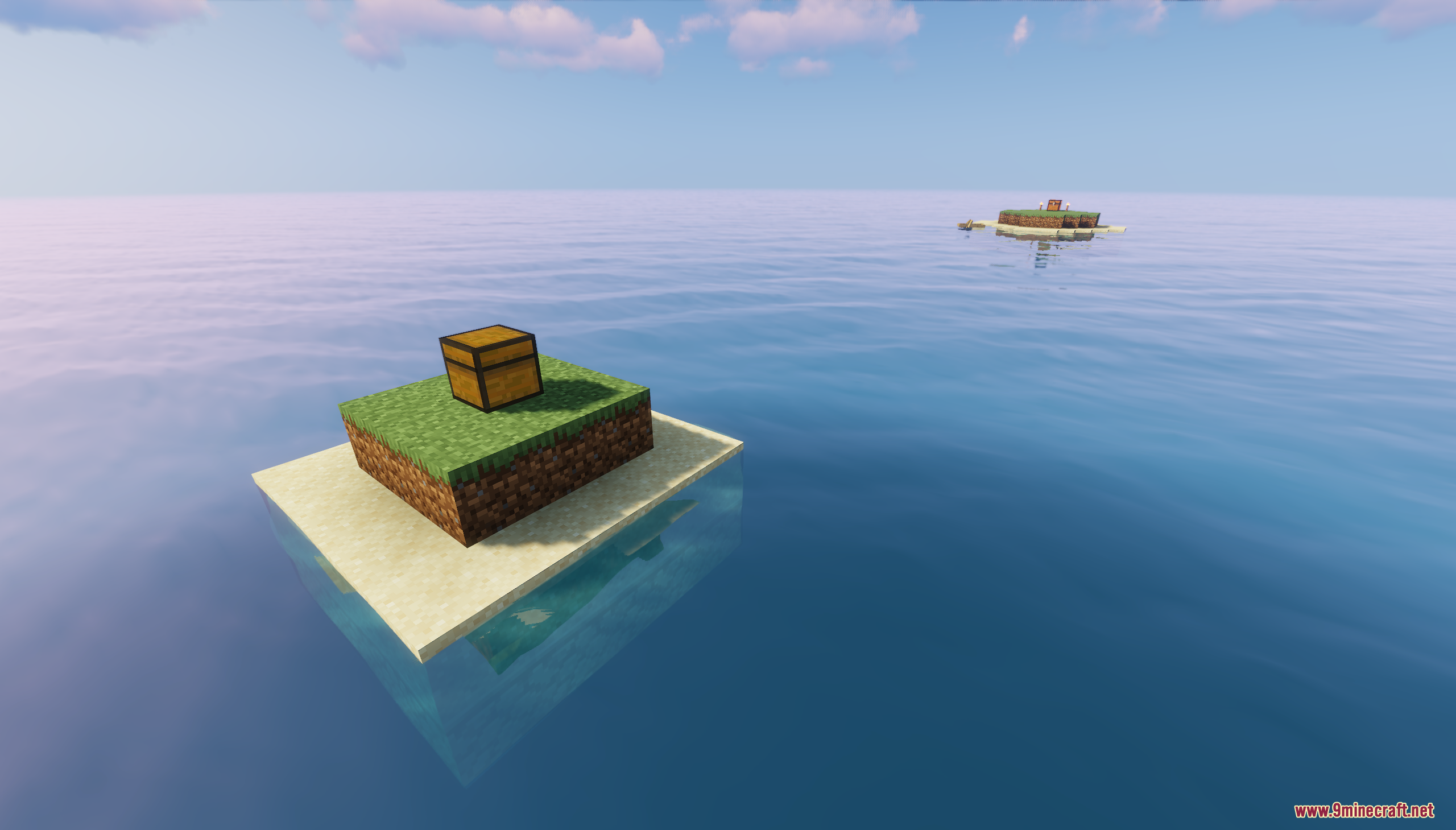 Small starting island and another distant island across the ocean water