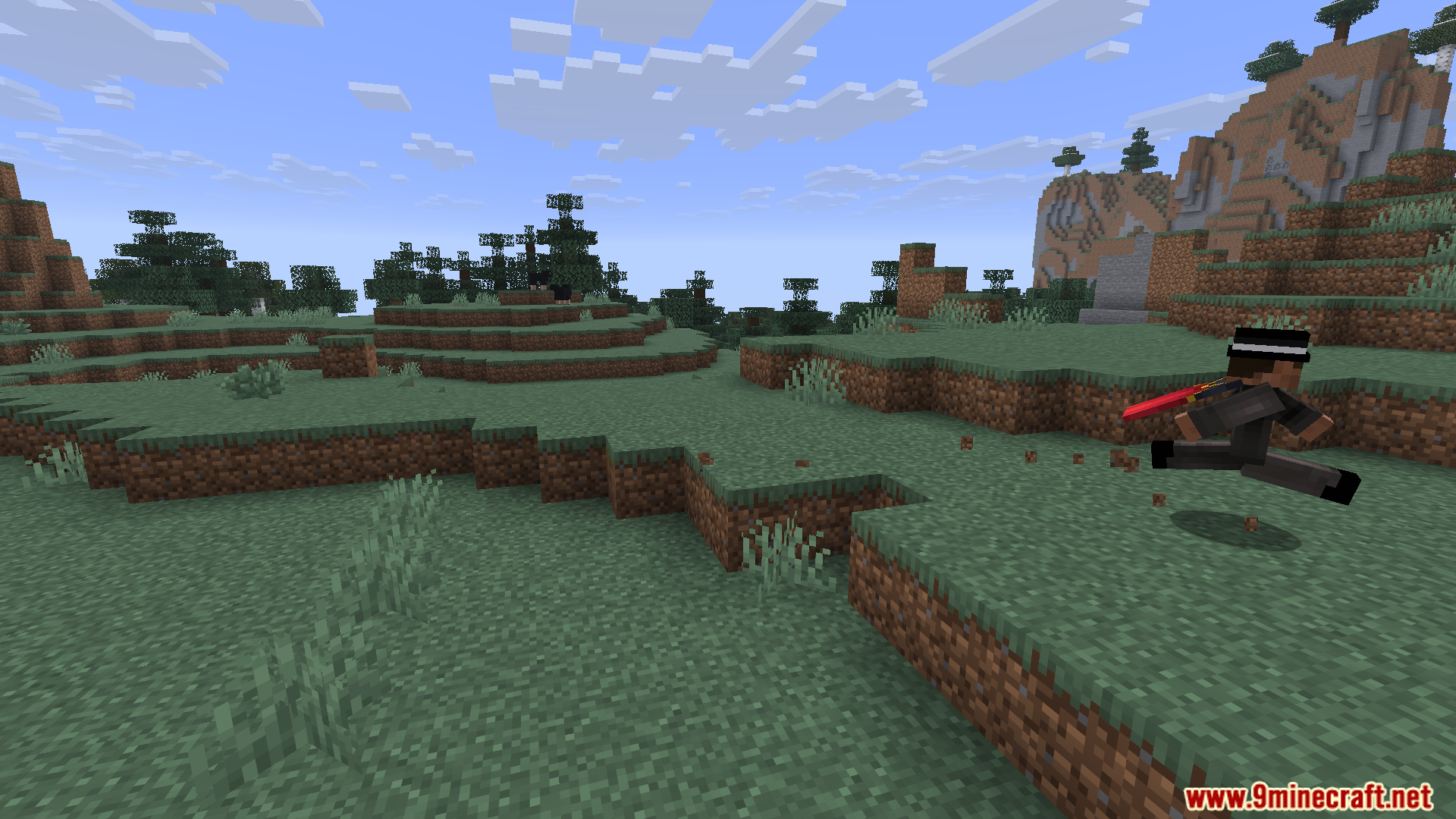 Player running across a grassy field holding a sword