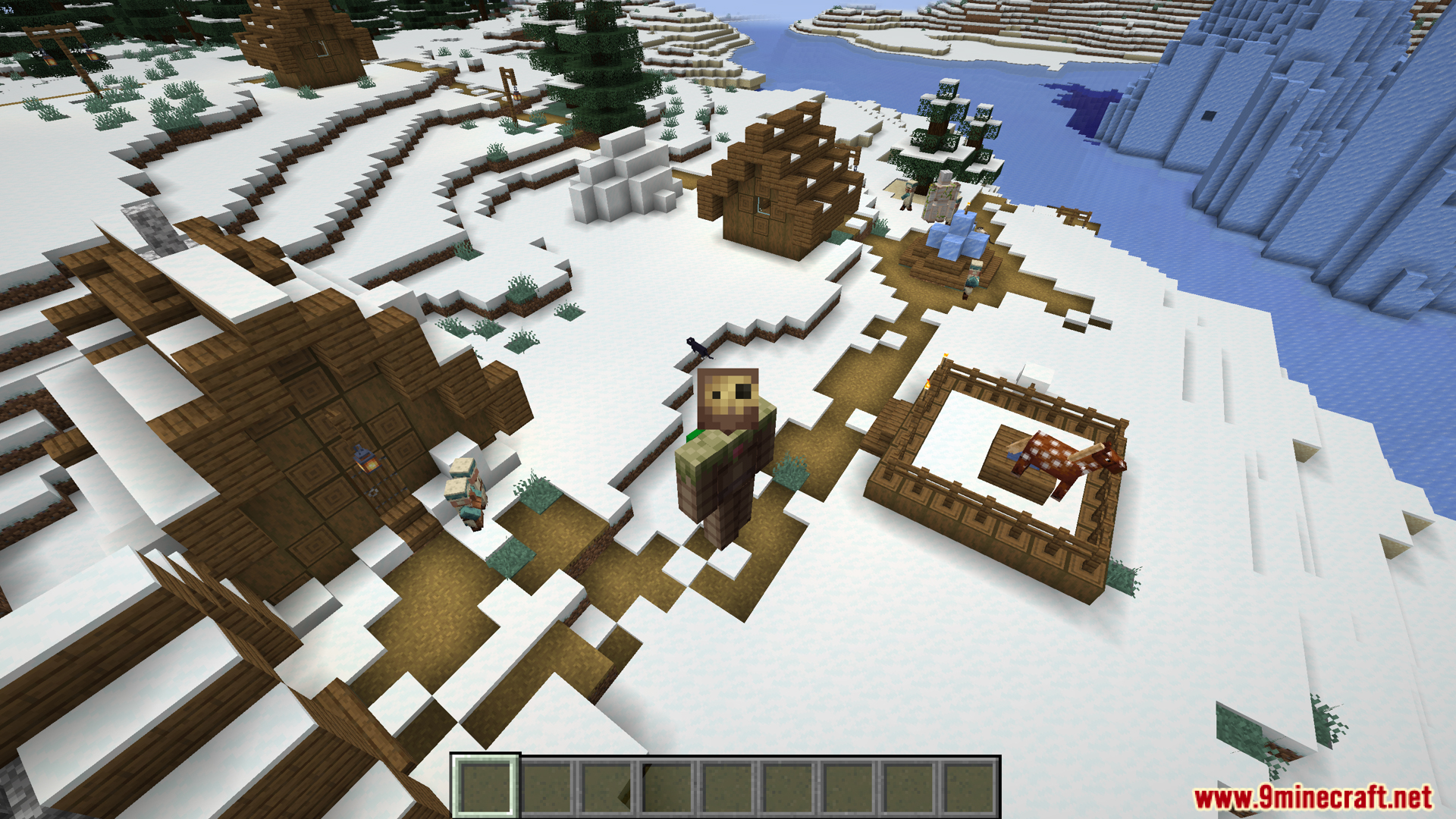 Player exploring a snowy village with mobs