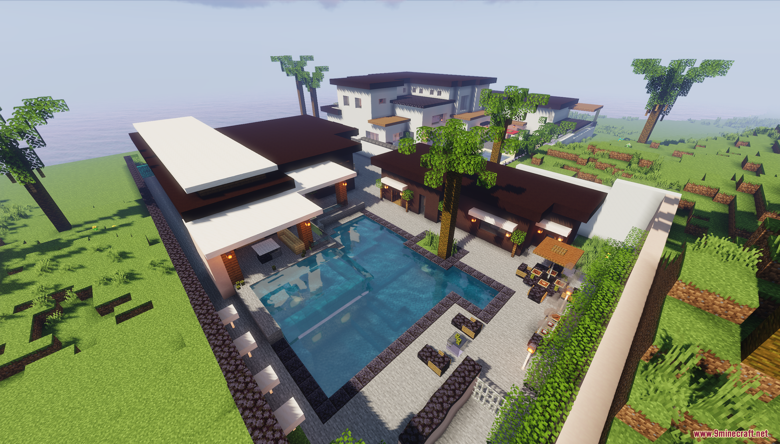 Modern house backyard featuring a large swimming pool and patio furniture