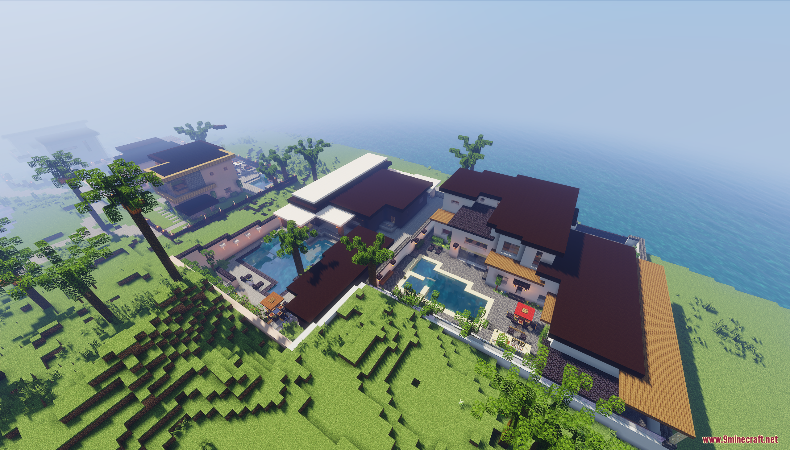 Aerial view of several modern houses with pools and yards