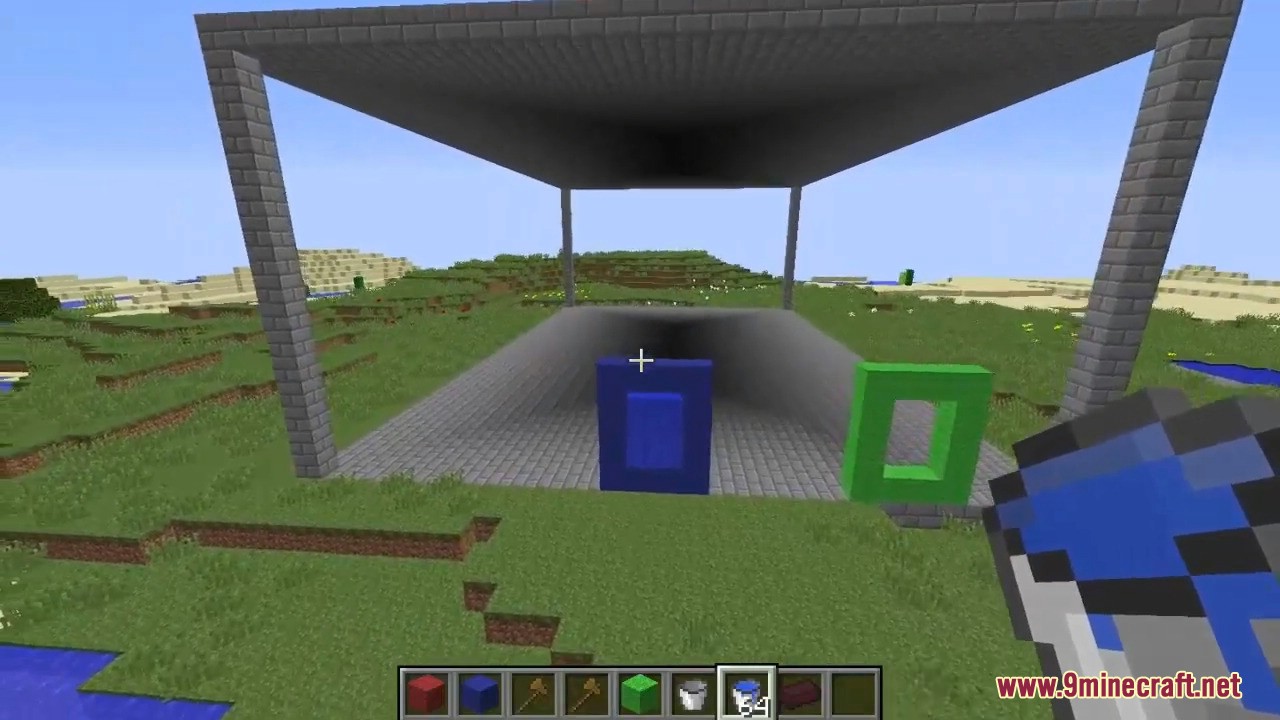 Player building custom portals with blue and green blocks and water