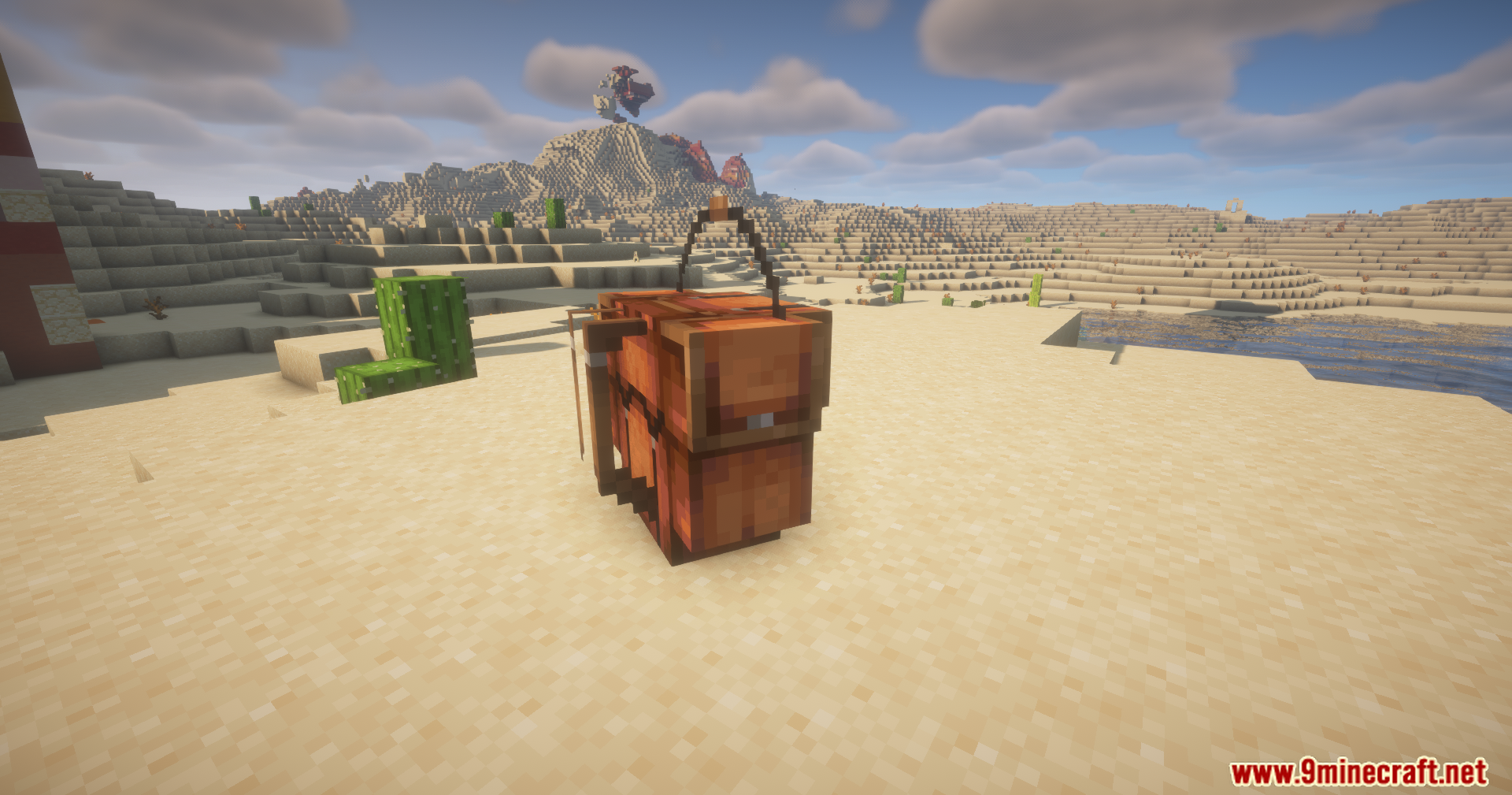 A large, detailed leather backpack placed on the sand