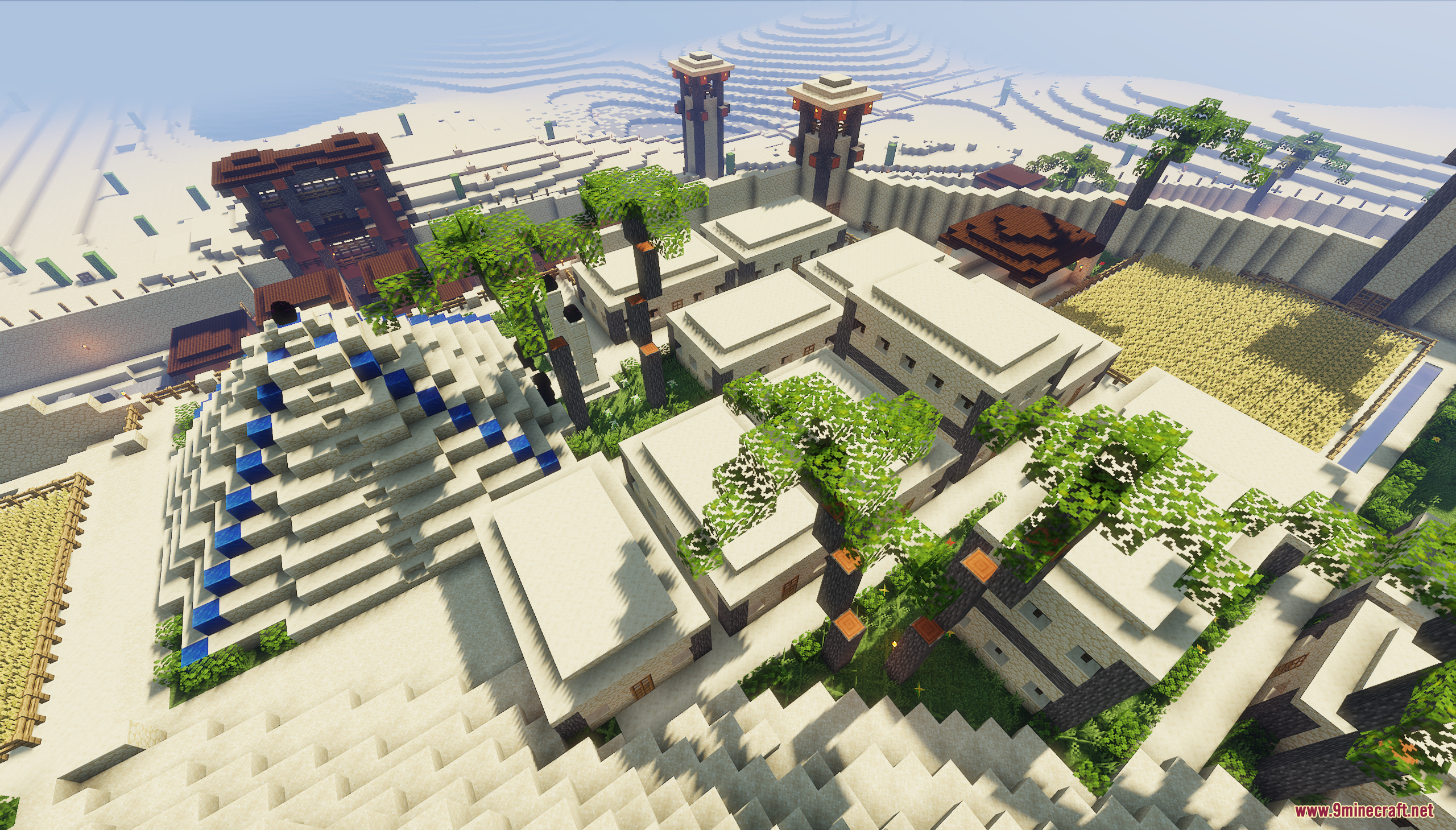 Aerial view of flat roofed houses and small blue accented pyramid