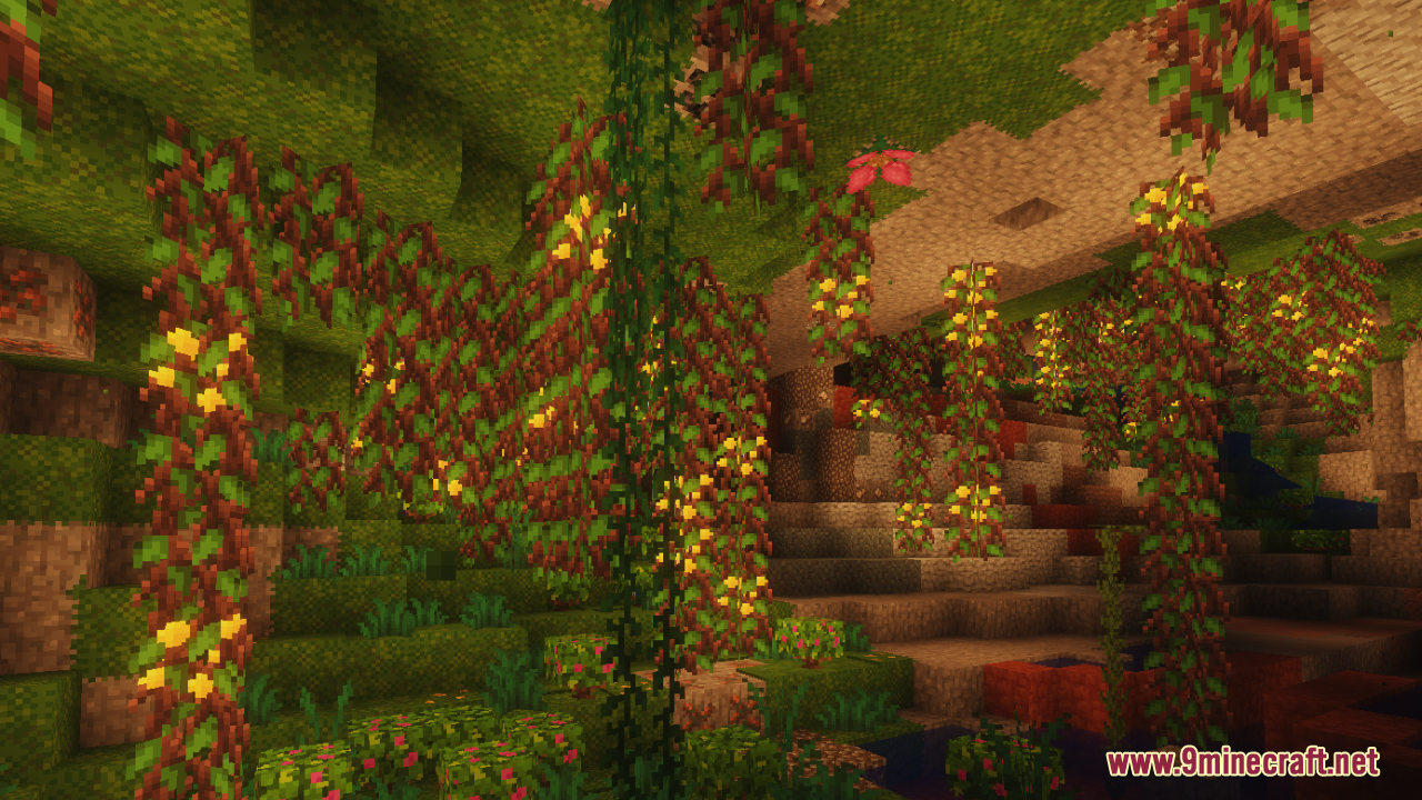 Lush cave interior showcasing hanging glow berries and mossy blocks