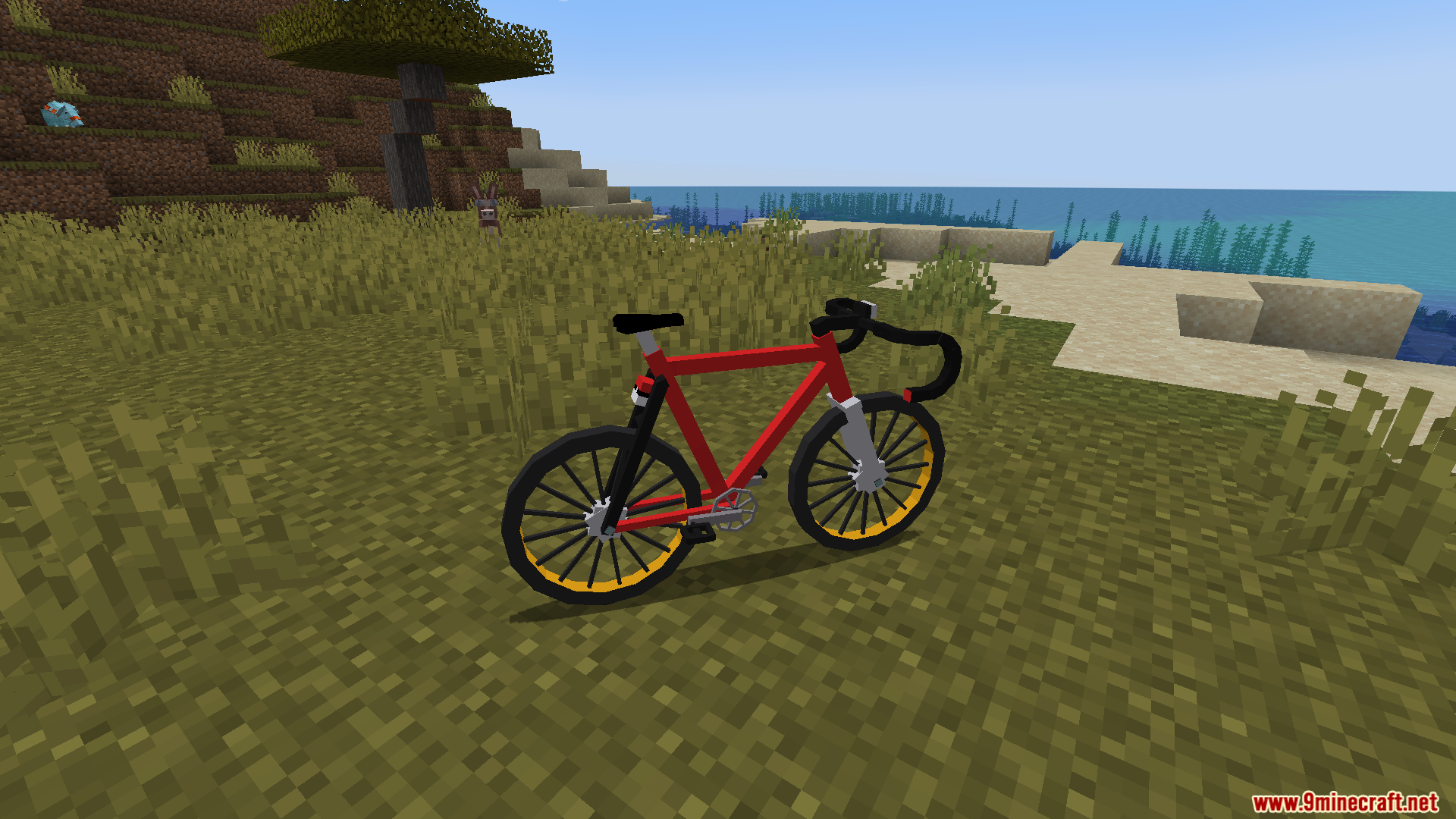 A red bicycle with yellow wheels on a grassy hill