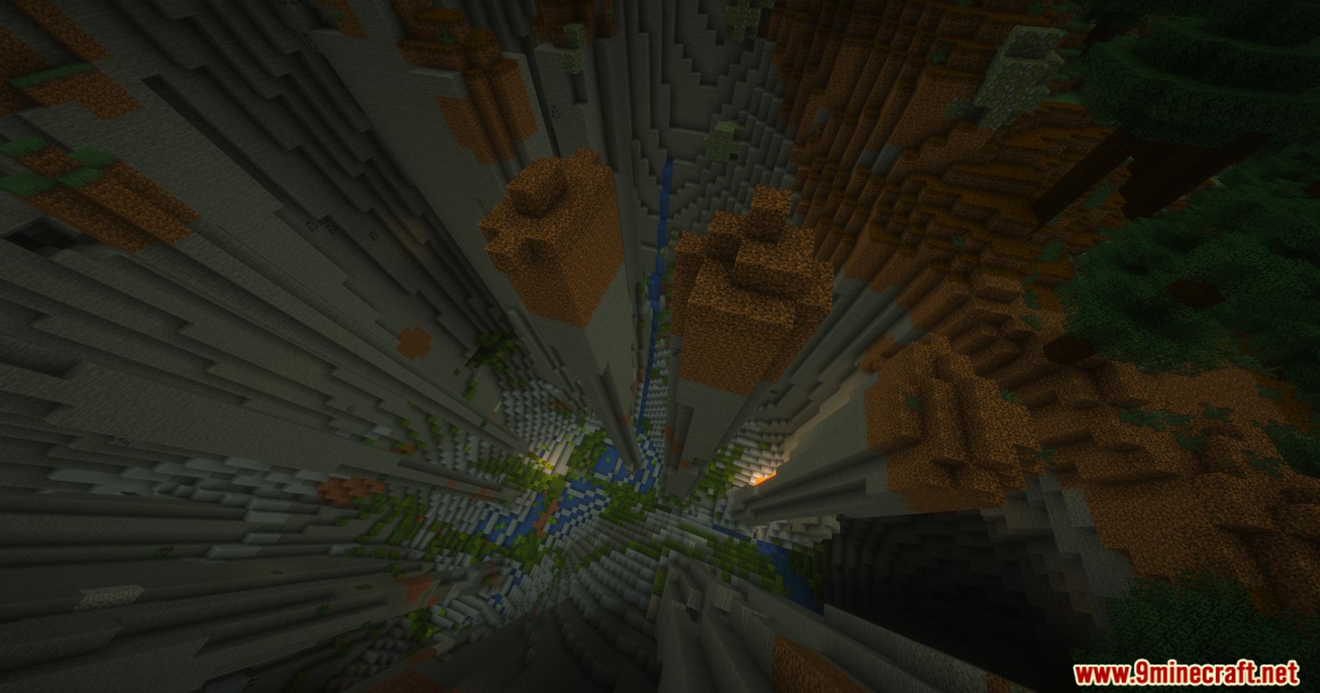 View looking down into a deep stone ravine with water below