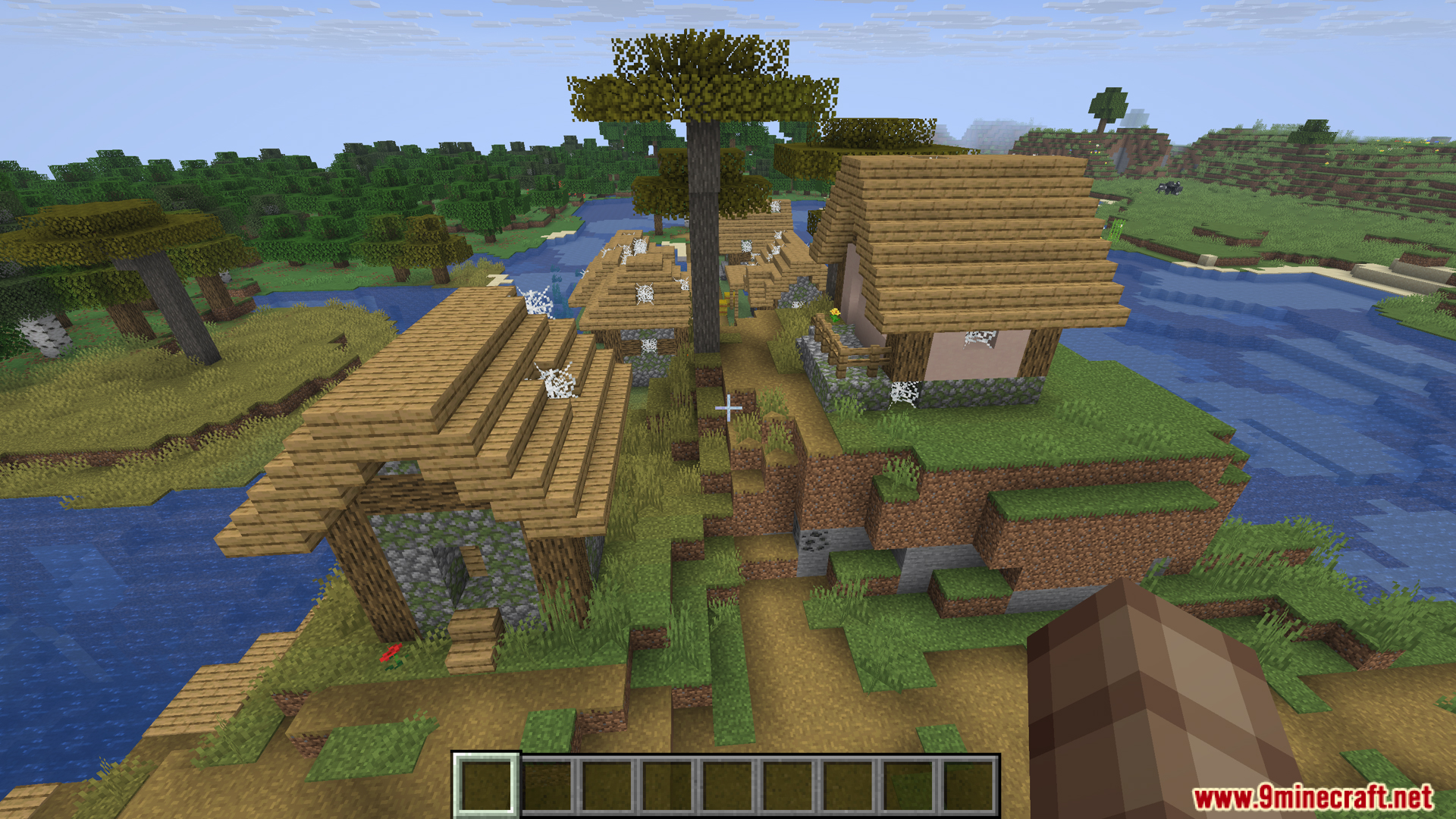 An abandoned village covered in cobwebs by a river