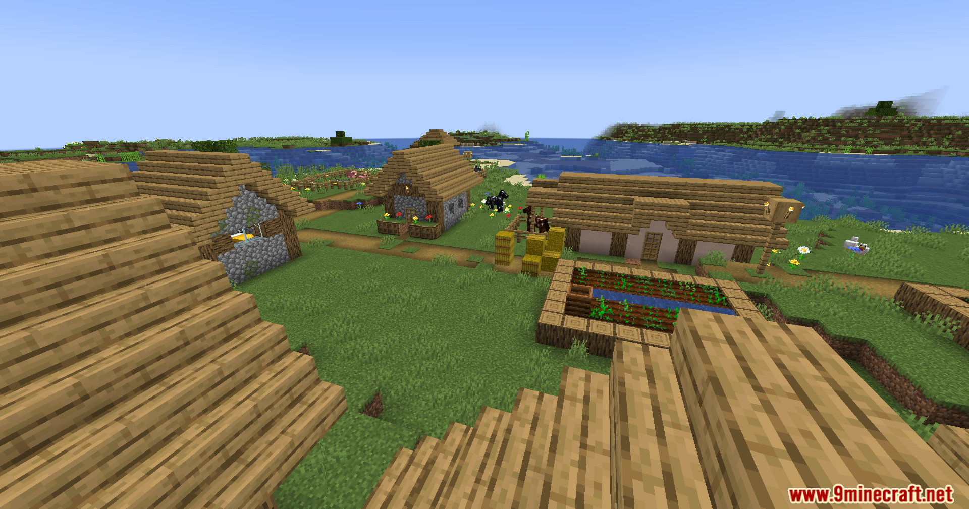 An elevated view of a Minecraft village near water